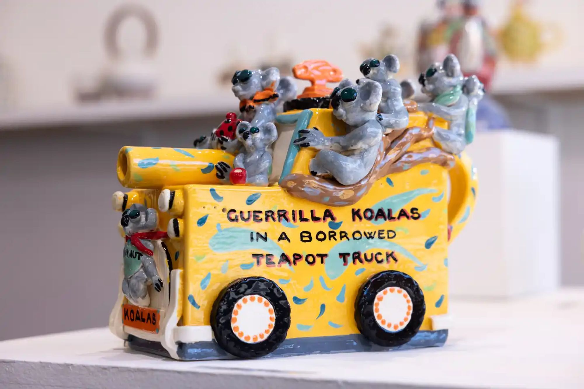 Guerrilla Koalas on a Borrowed Windup Teapot by Janice Raynor
Using humor and a sculptural approach, artist Janice Raynor’s teapot aims to bring attention to ‘the reality that koalas are still endangered due to habitat loss as eucalyptus corridors are increasingly cleared and lost in bushfires’. Her hand-built pot depicts a dozen ‘guerrilla koalas’ who ride an environmentally-friendly wind-up truck, patrolling and protecting their forests. ‘These “vigilantes” drink gum leaf tea from a red dotty teapot and sing rousing koala gum tree songs,’ Raynor says. More than telling stories about environmental protection, Raynor also practices it, using a solar-powered kiln to create her ceramics.

Photograph: Blake Sharp-Wiggins/The Guardian