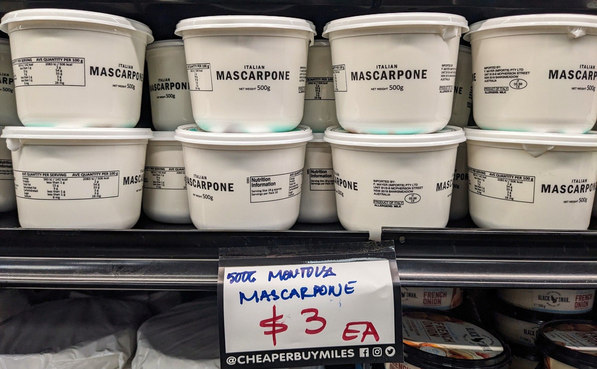 Several half-kilo tubs of Mascarpone stacked on a supermarket shelf, $3 each