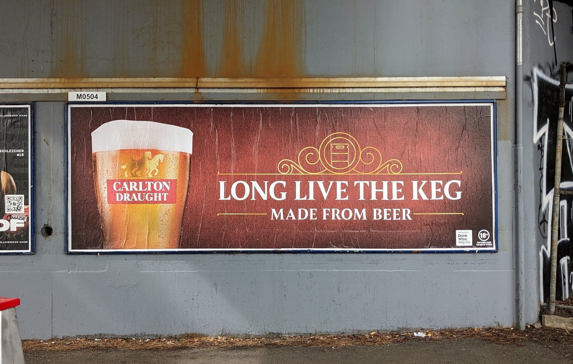 A Carlton Draught billboard in a grimy highway overpass. Bedside a glamour shot of a pint are the slogans "Long Live The Keg" and "Made From Beer".