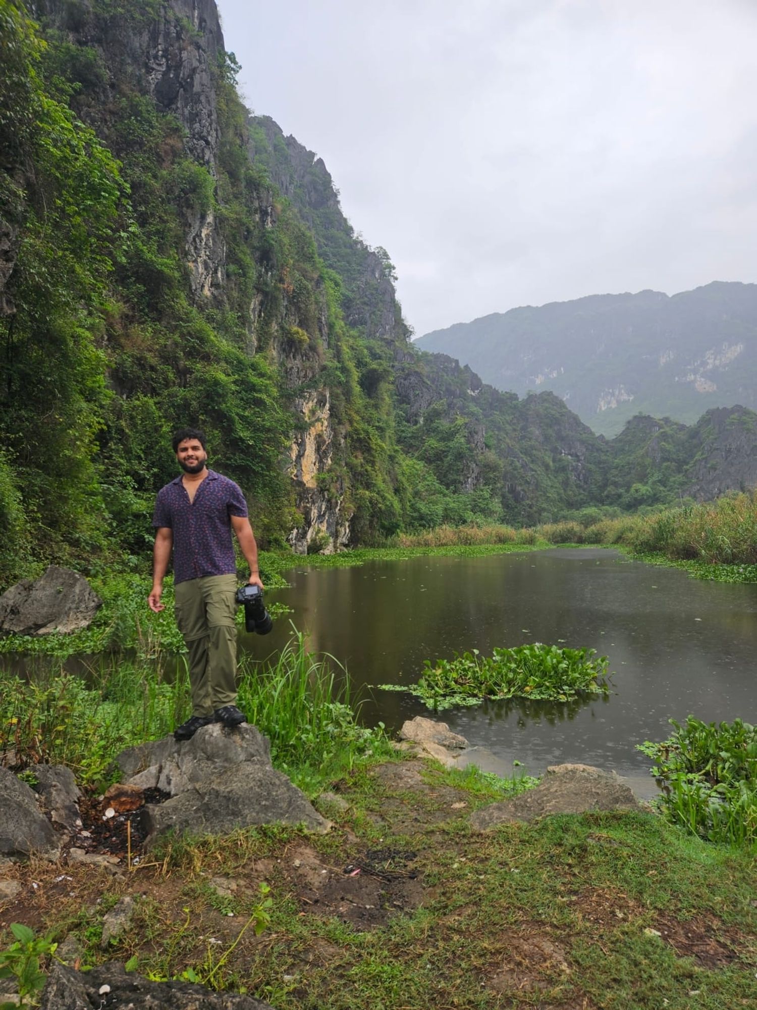 a picture of me next to a lake with limestone hills in the background