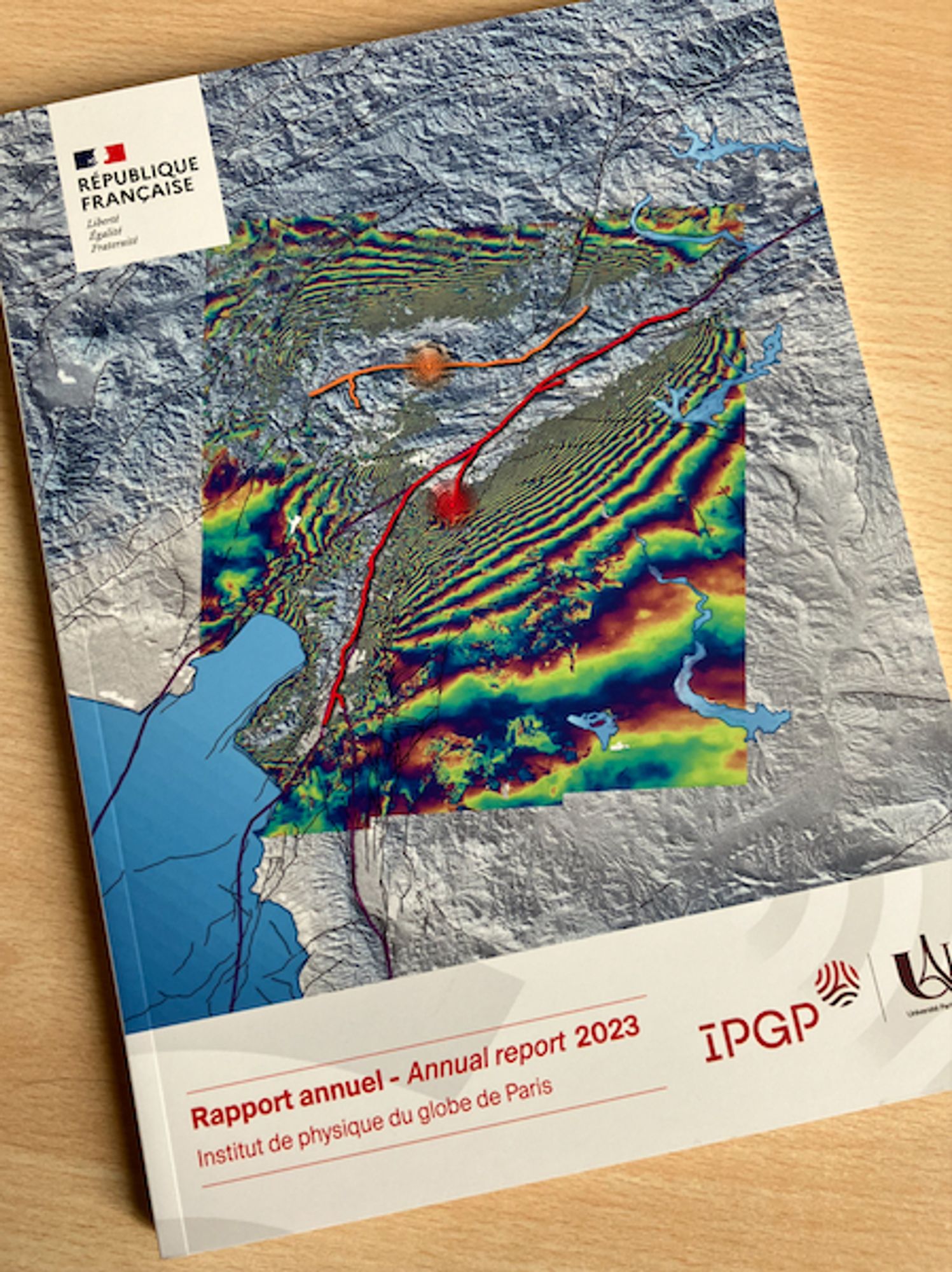 Photo of IPGP report's cover page showing a Sentinel-1 interferogram of the doublet of earthquakes that struck Turkey and Syria on 6 February 2023. InSAR fringes shown in colour outline the coseismic deformation. Fault ruptures are figured as red and orange lines.