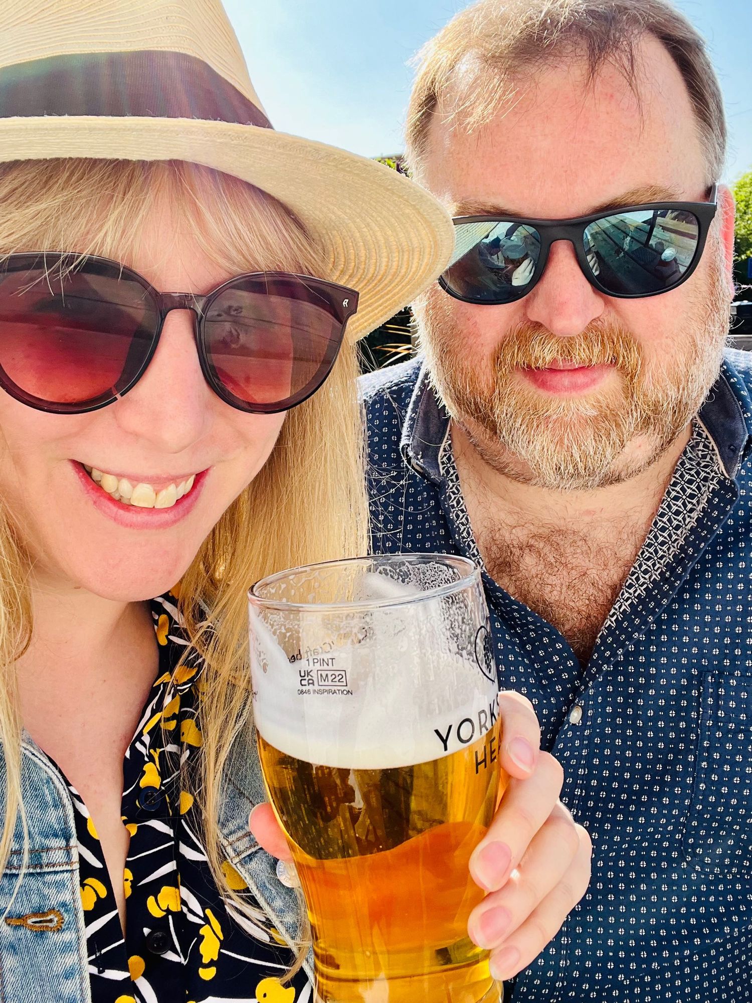 Hannah and Stu are drinking beer in the sunshine and feeling good! 