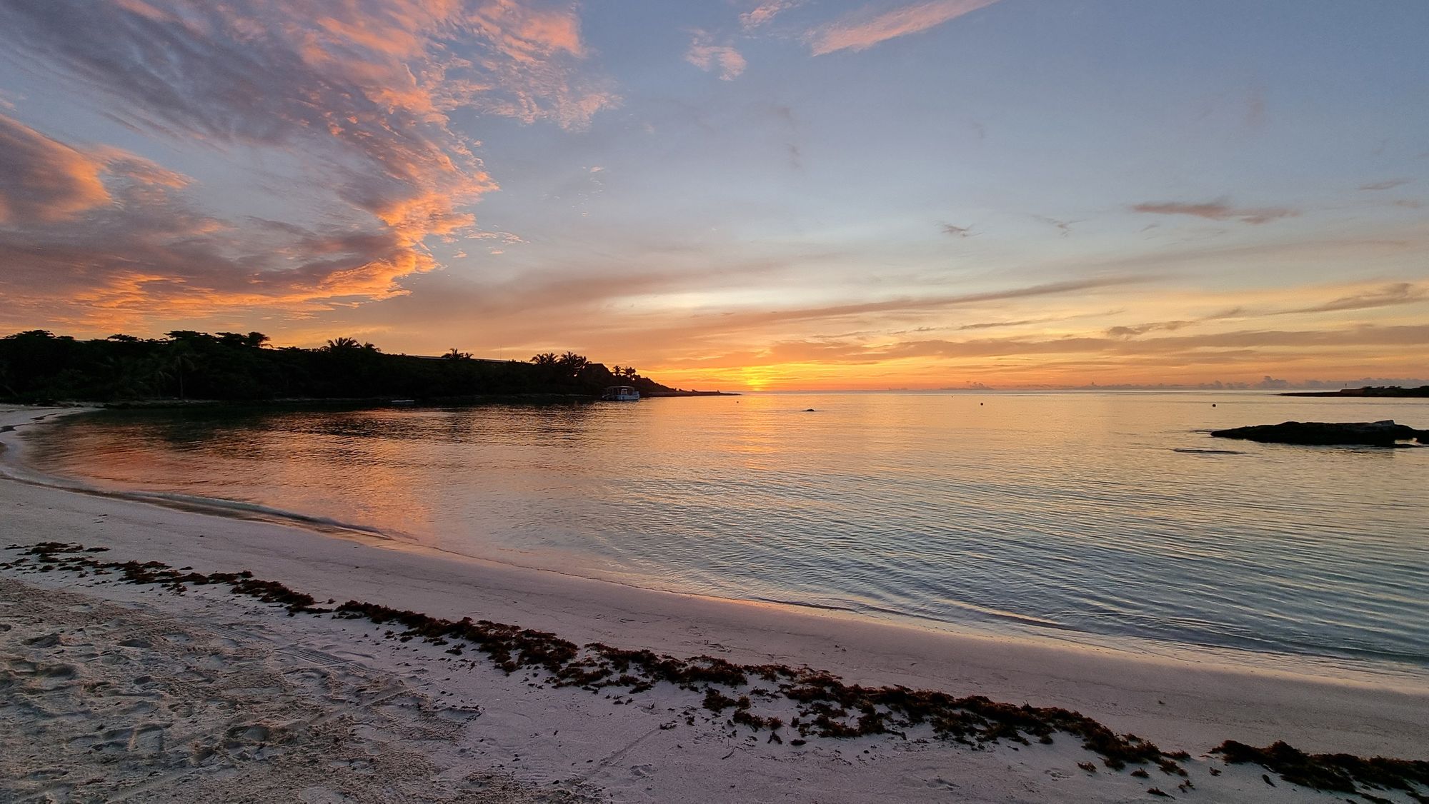 Sun rising over the sea as seen from a tropical beach.