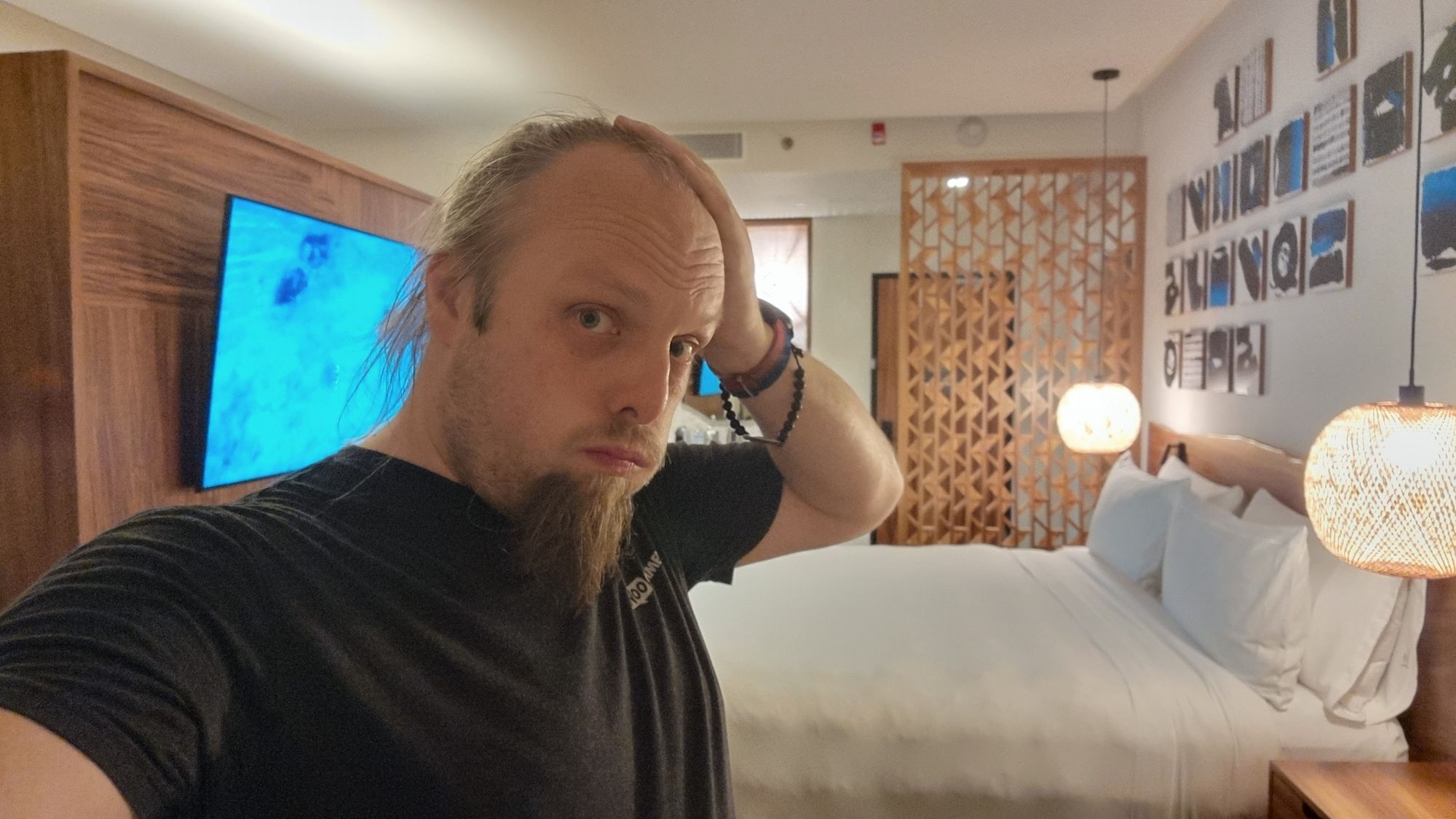 Dan, looking tired, in a hotel room. 