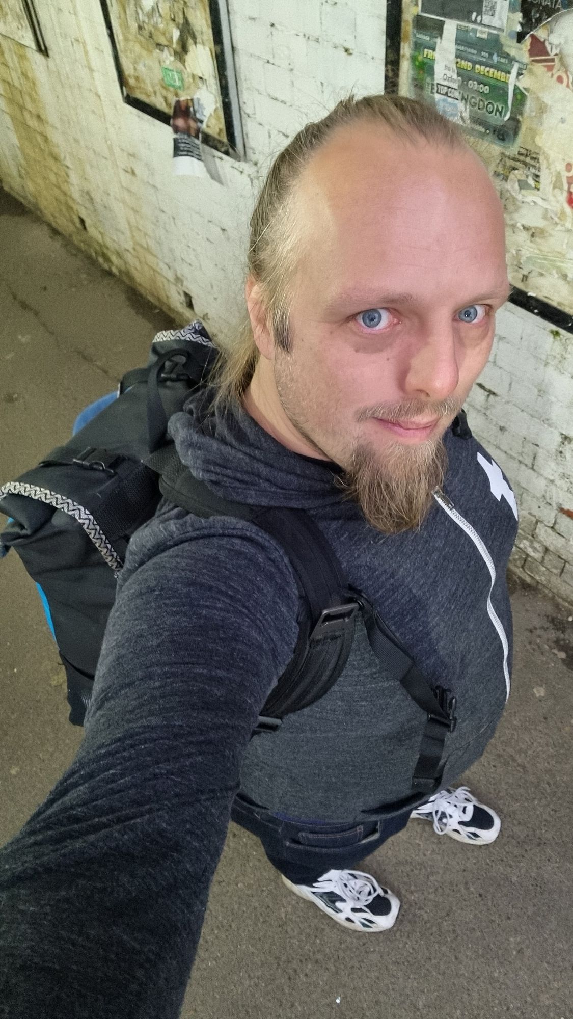 Selfie of Dan in a tunnel walkway wearing a backpack.