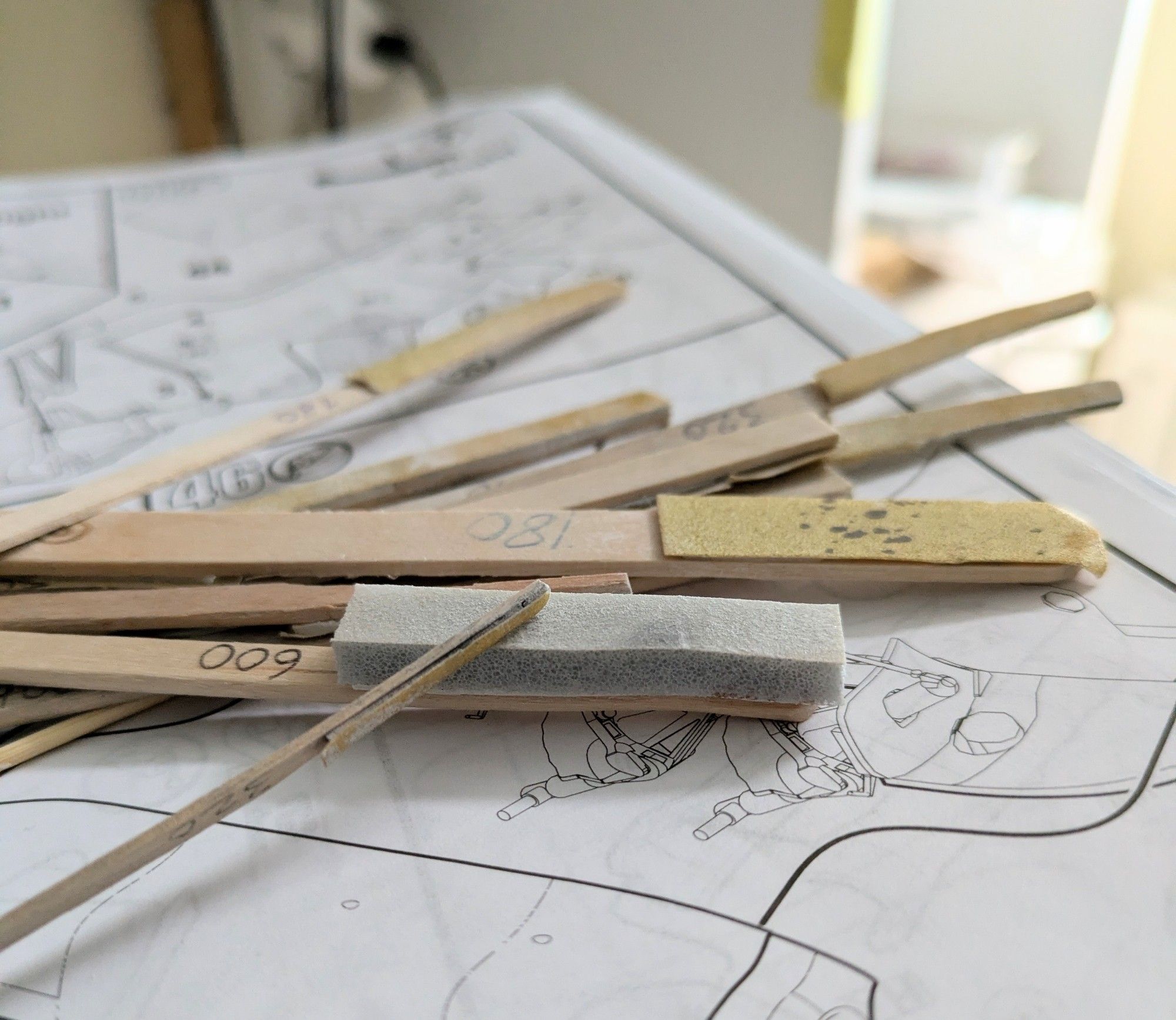 Picture of a bunch of home-made sanding sticks.