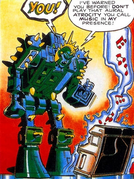 Fang from the Transformers UK marvel comics. He is looking down at a piano playing music. He is saying in a speech bubble "YOU! I've warned you before! DON'T play that aural atrocity you call music in my presence"