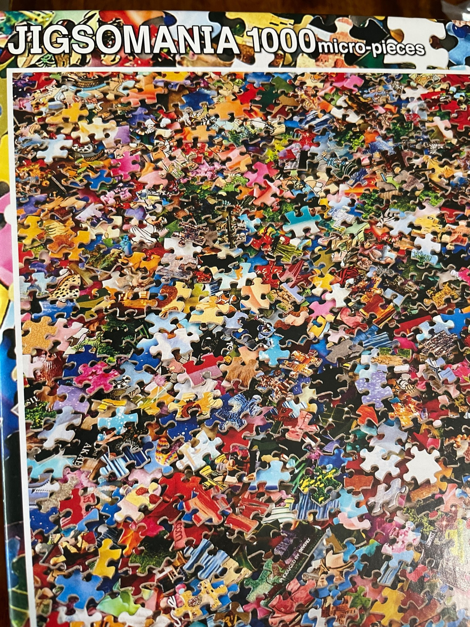 Cover of a puzzle box showing a puzzle of spilled puzzle pieces.