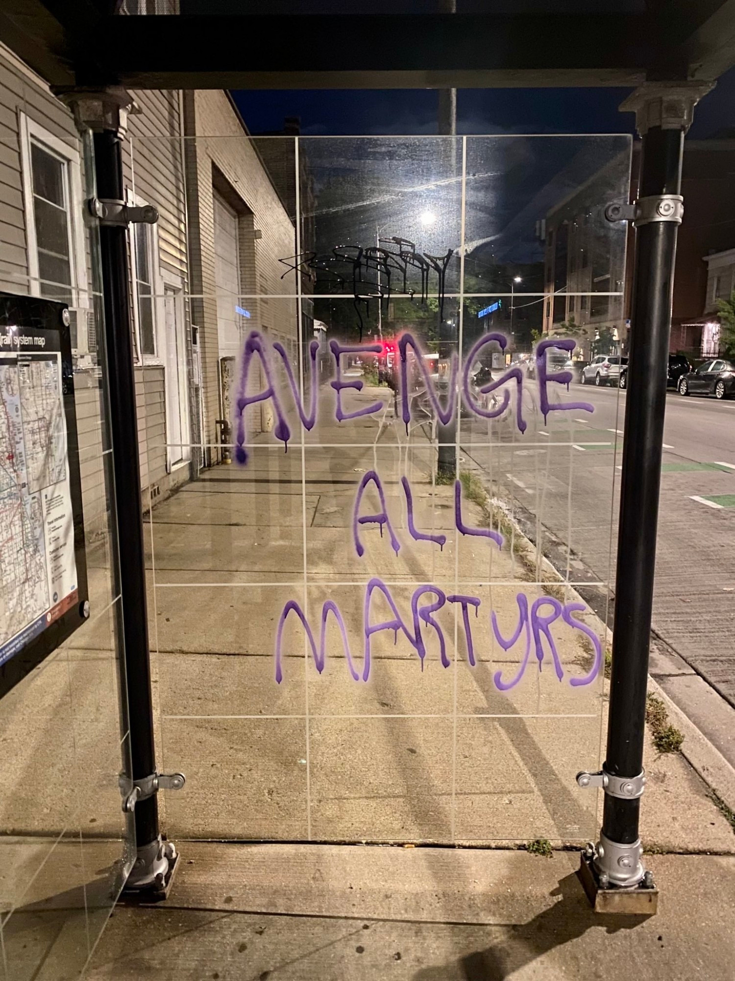 Graffiti on CTA bus shelter: AVENGE ALL MARTYRS