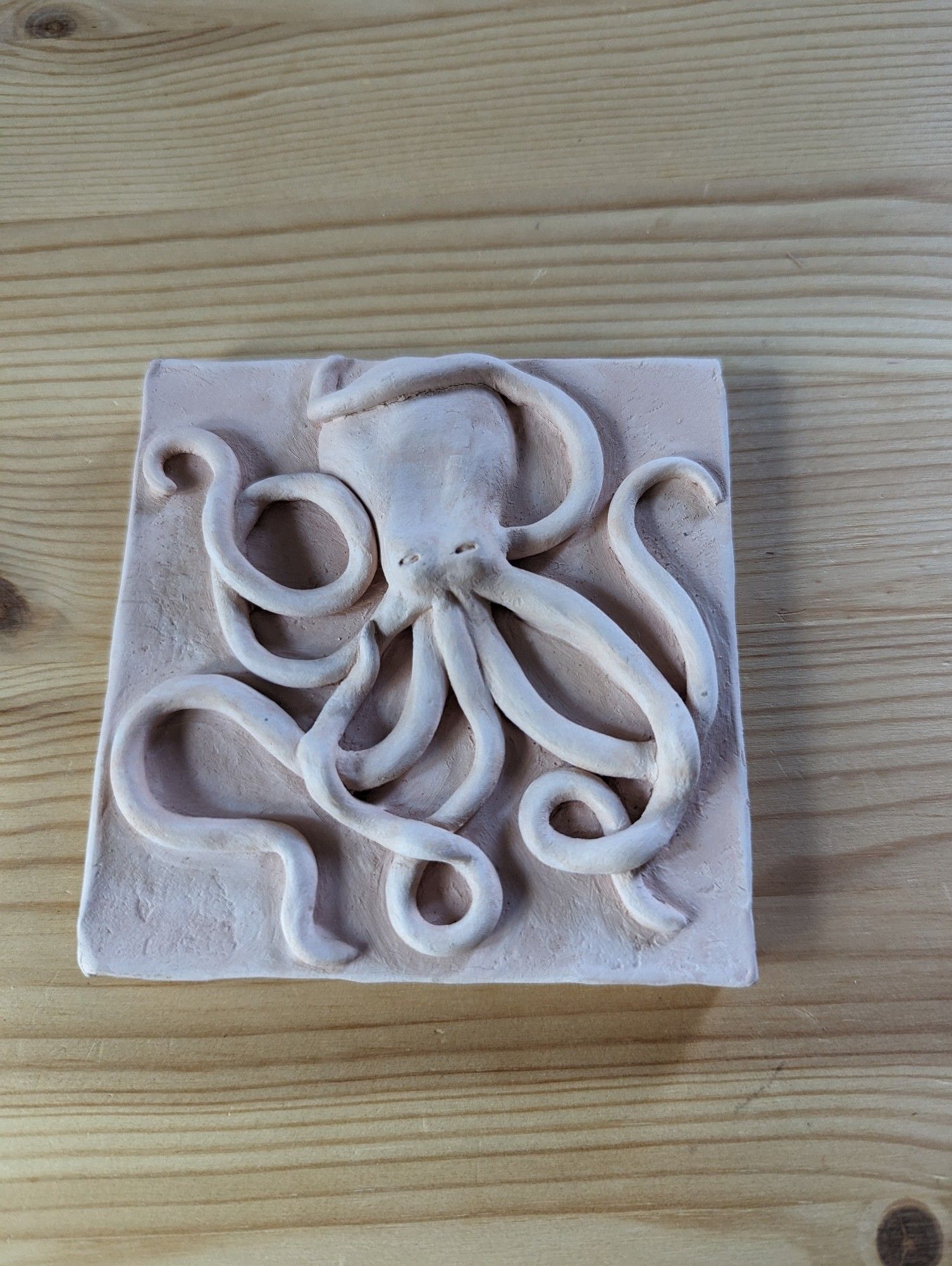 Clay tile with a raised octopus design