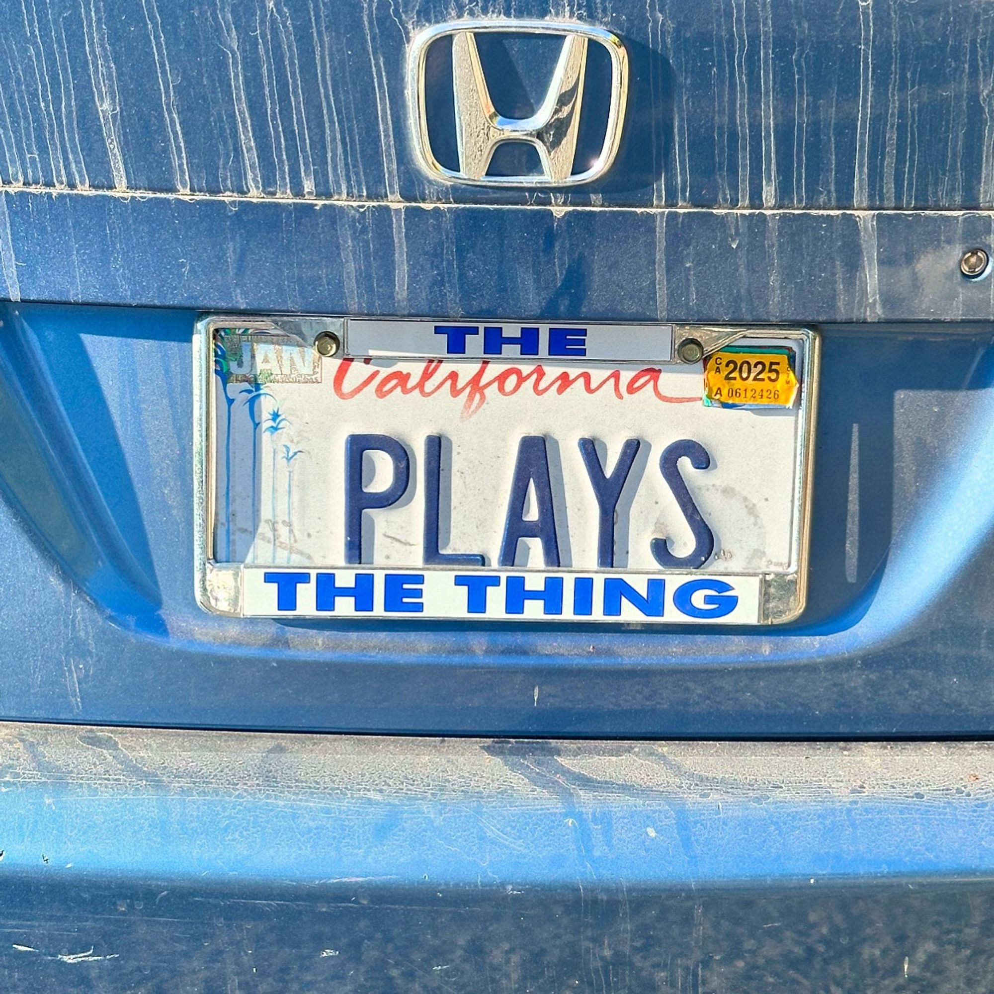 California license plate on a Honda in need of a wash, reading PLAYS, with a custom frame so that it reads “The PLAYS the thing.” Incidentally, the previous photo was also of a Honda (embarrassingly mislabeled as a Hyundai)