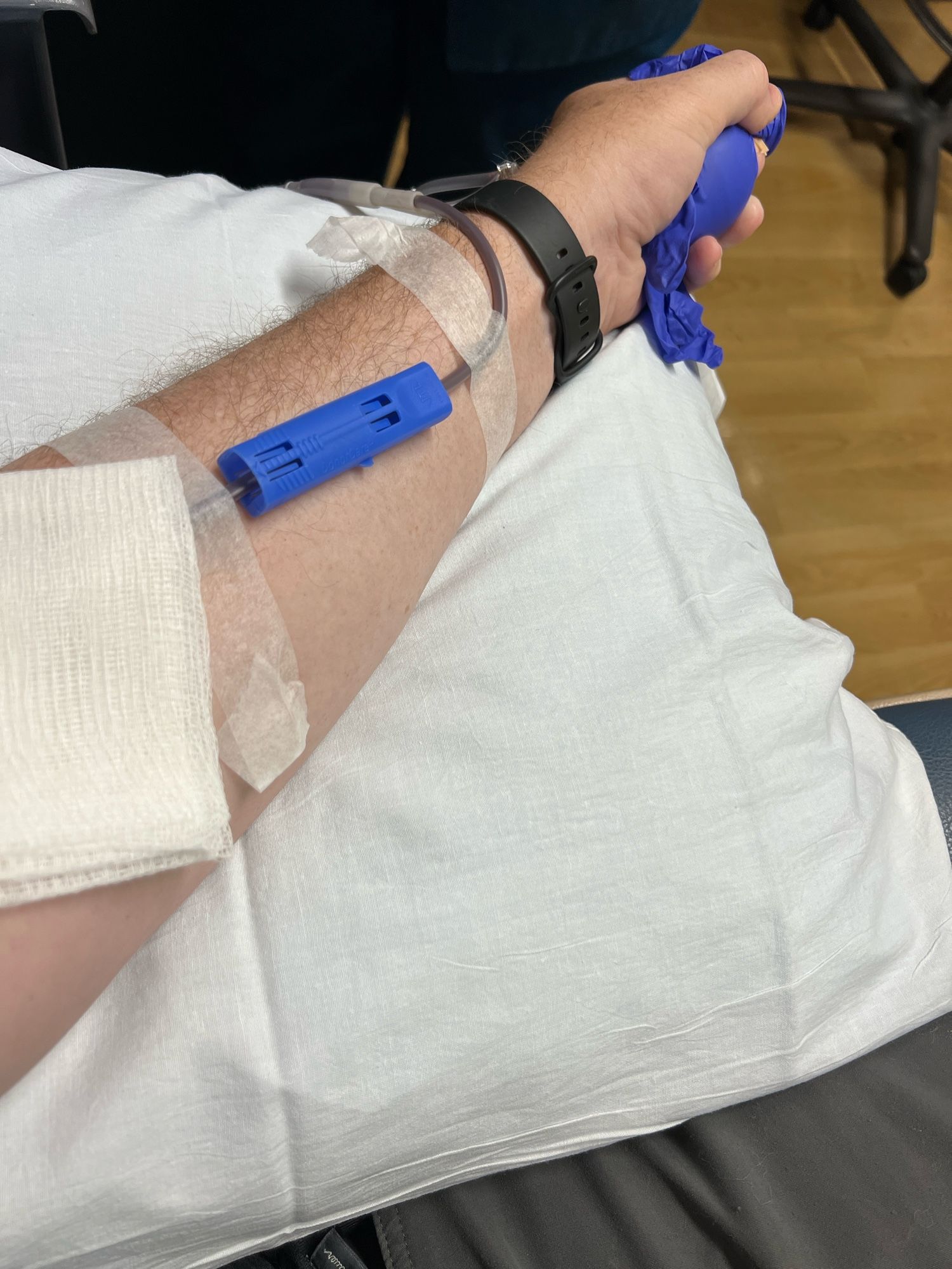 An arm with blood donation tubes in it.