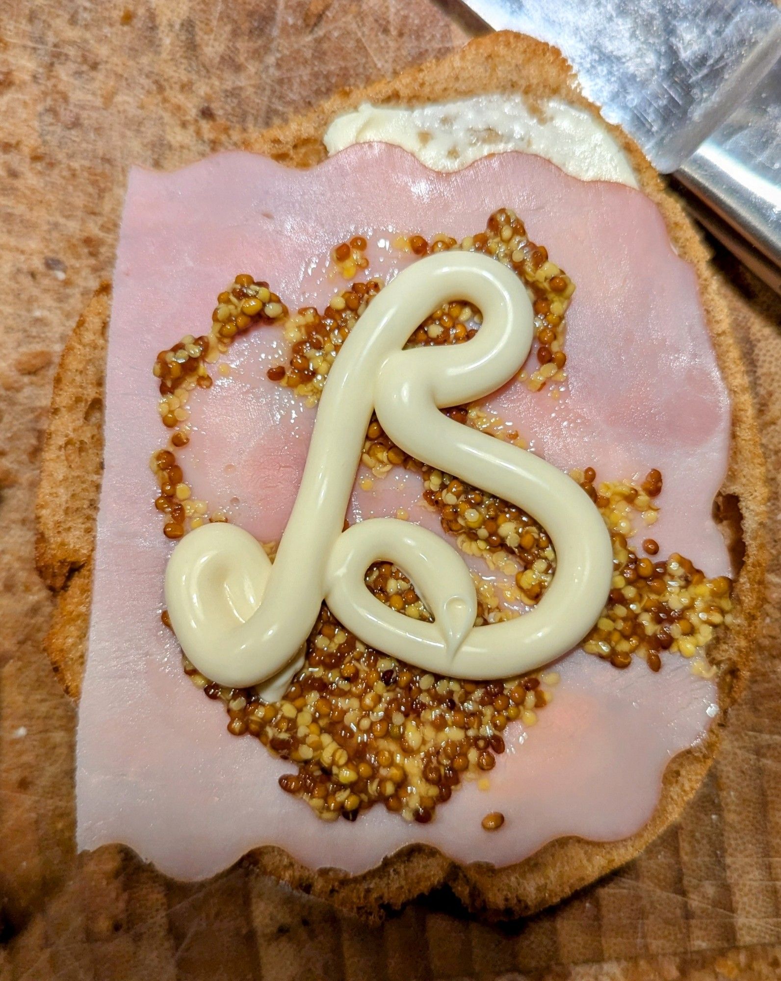 Obnoxiously euro open faced sandwich with butter, ham and coarse mustard. The letter B is louchely written on it in korean mayonnaise. Please don't unfollow, I'm high as balls