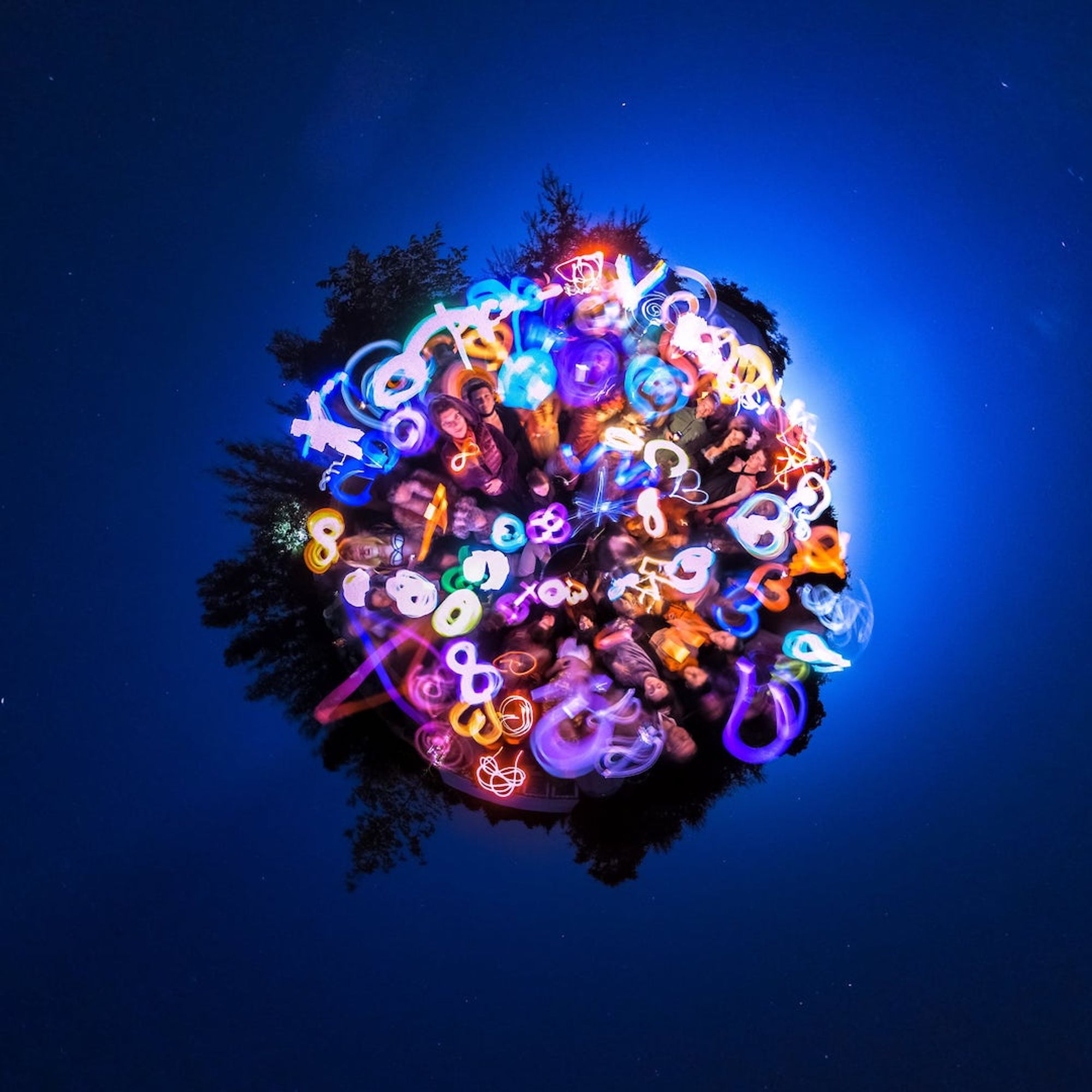 360 degree lightpainting in which dozens of people paint hearts and other positive symbols with light. The 360degree picture is a tiny planet, so it looks like a tiny planet of light in the night sky with some stars visible.