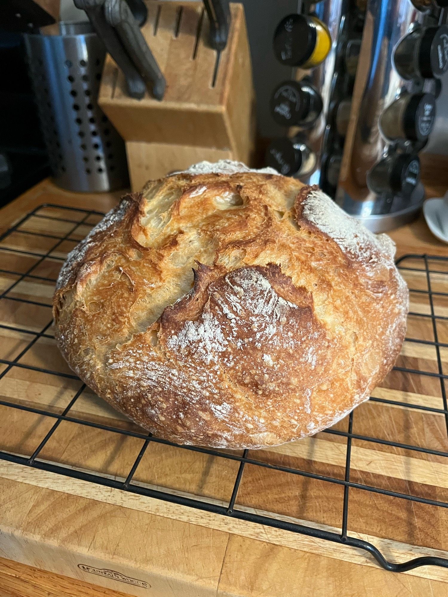 Another round loaf of bread cooling on the rack.