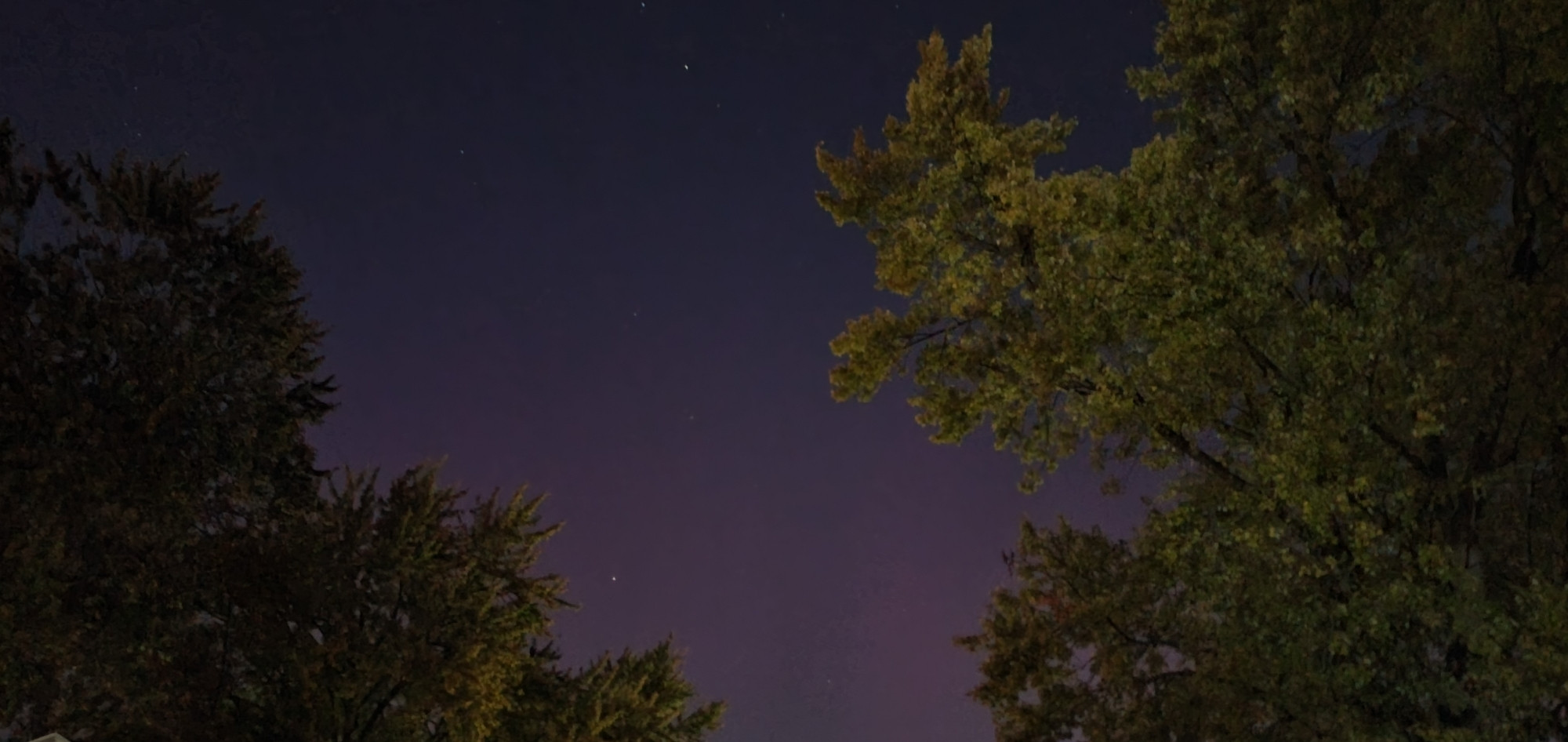 Slight purplish luminescence in a dark sky from Aurora borealis