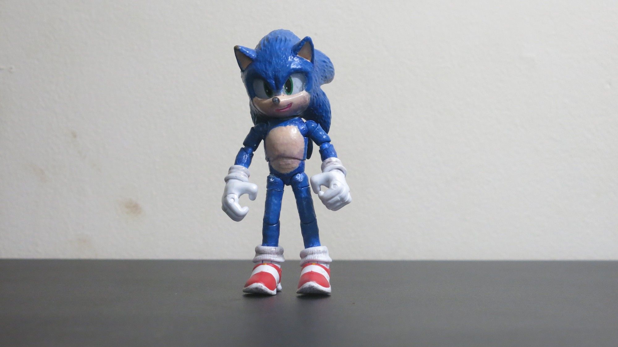 Sonic action figure from Sonic the Hedgehog 3. He's been repainted to a deeper blue with some variation on the shade