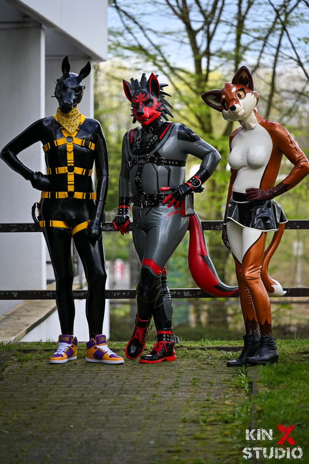 Black/yellow rubber pony, black/silver/red rubber wolf and rubber vixen standing next to each other casually