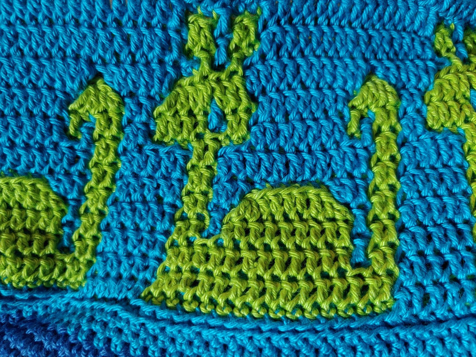 Close up of one Nessie motif showing the stitches. She's made in the overlay mosaic crochet style, done in double crochet.