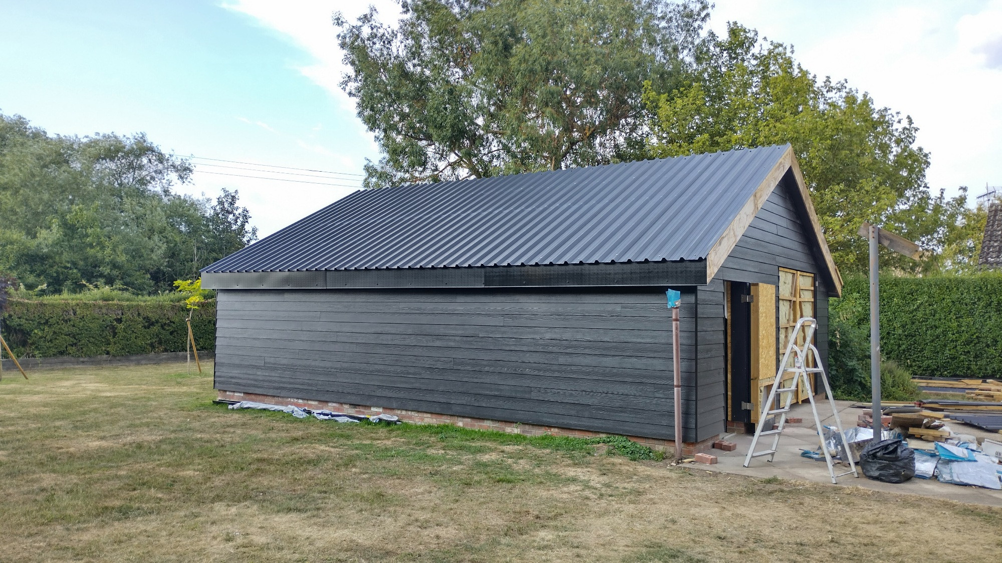 Black steel roofing sheets on timber framed workshop 