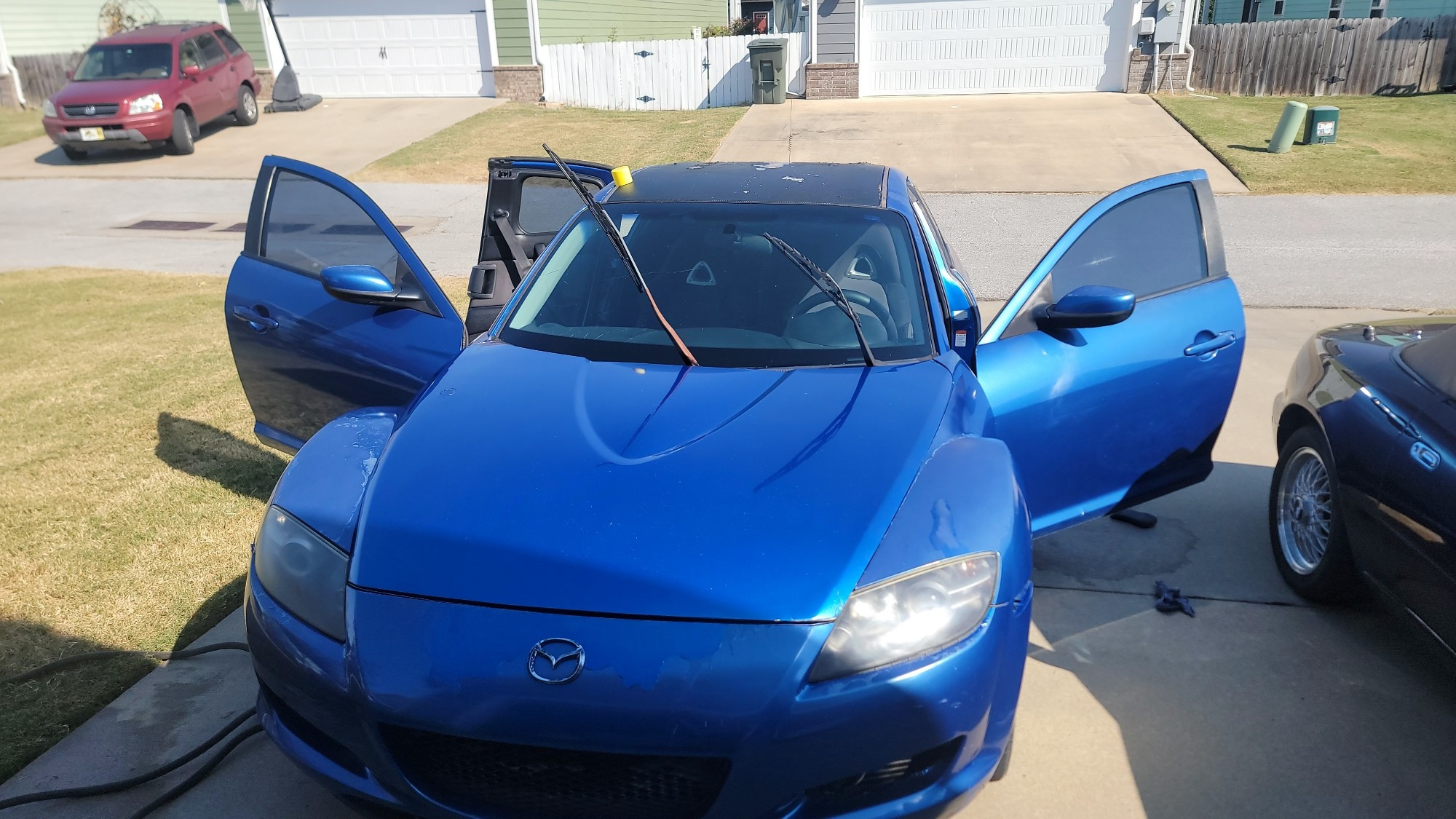 Blue Mazda RX-8 with open doors, front