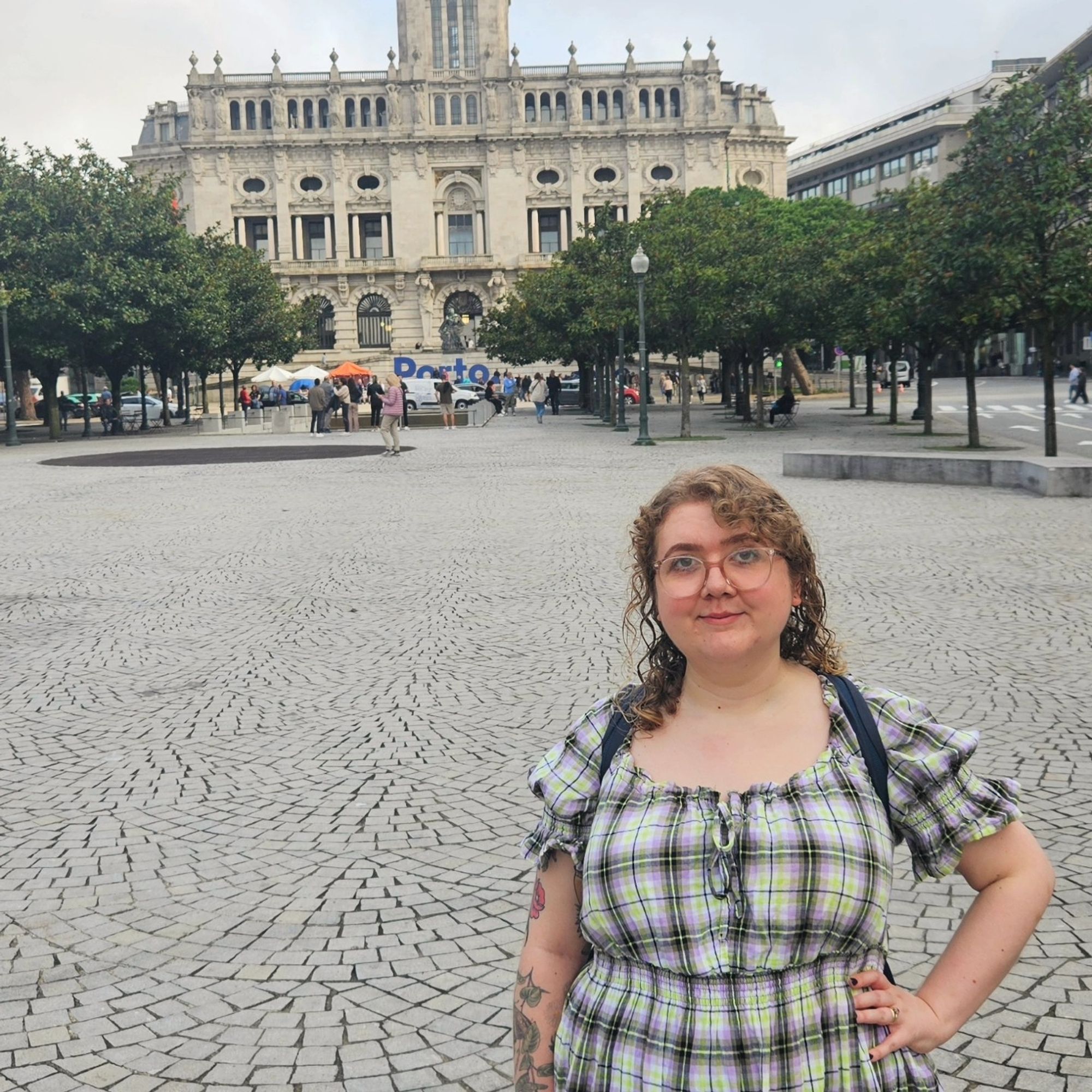 I am standing distantly in front of the Porto sign on Avenida dos Aliados.