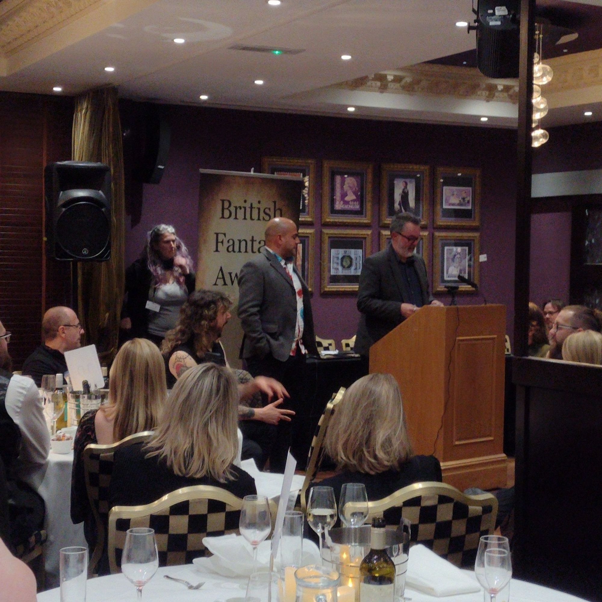 Robin CM Duncan announces another prize while Stew Hotston, MC for the BFAs event looks on, and Karen Fishwick hovers behind to wrangle prize envelopes etc.