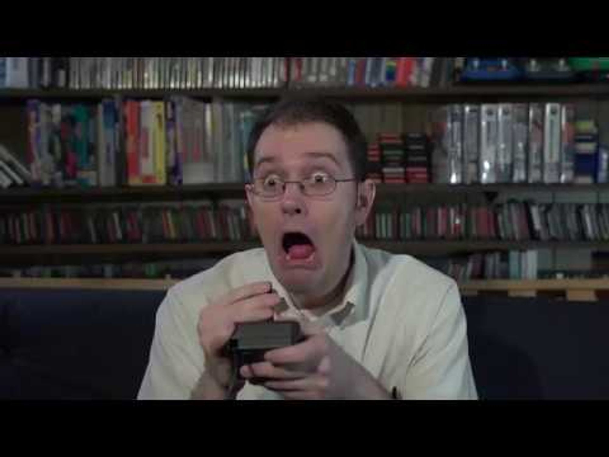 Screenshot of the AVGN holding a Atari 2600 controller, he is looking extremely surprised.