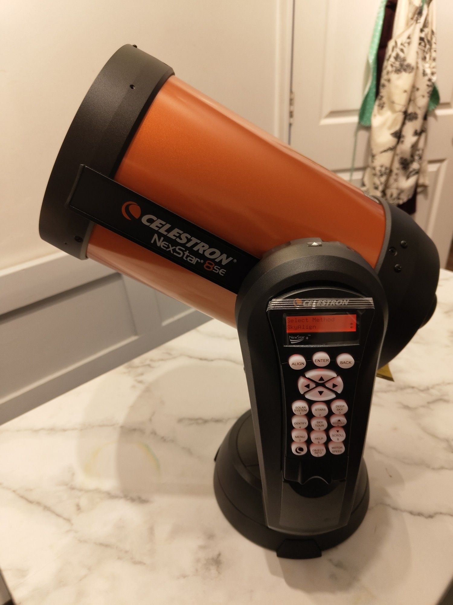 picture of a celestron nexstar 8se telescope on a table.