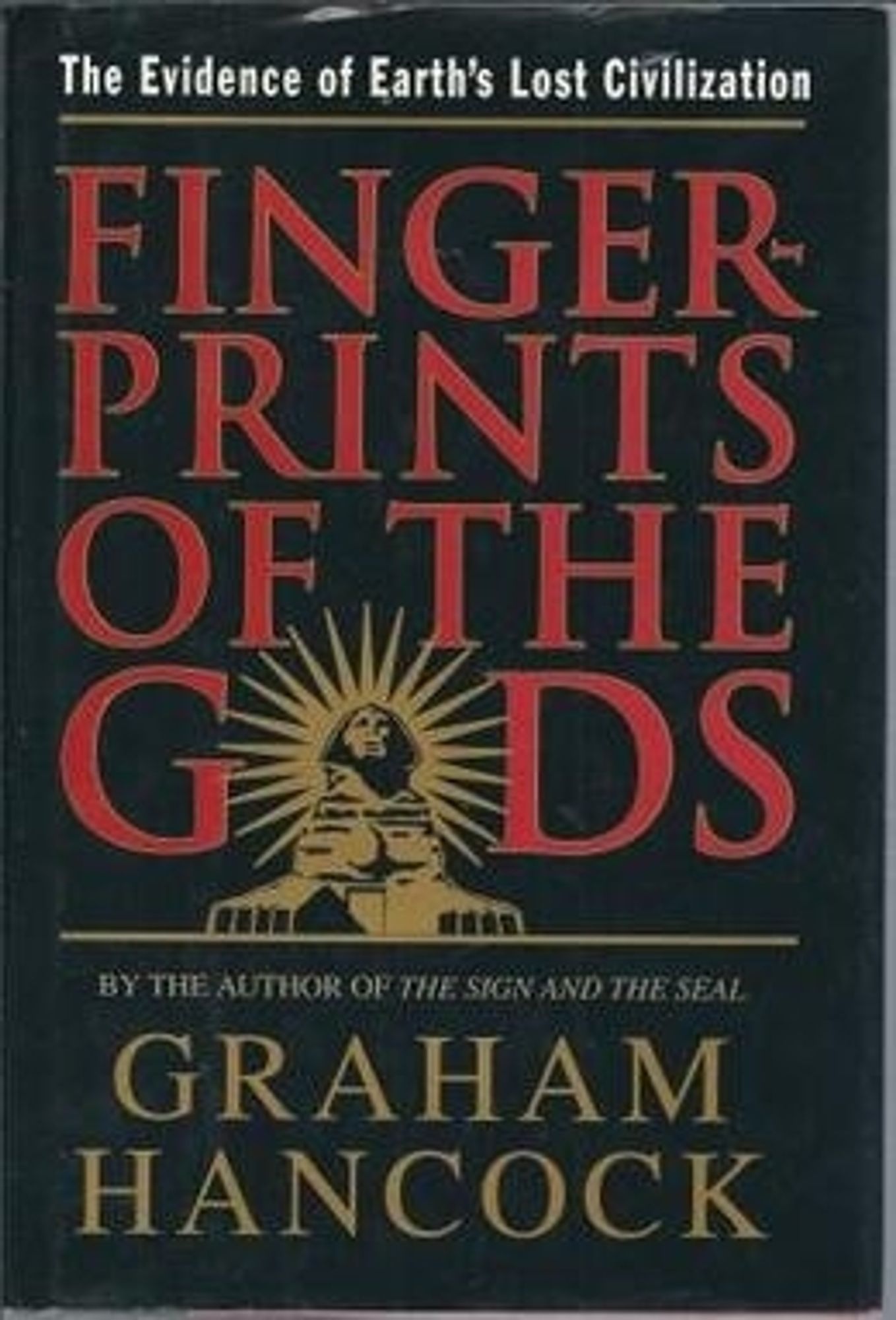 Cover for the book Fingerprints of the Gods by Graham Hancock.

Cover has a black background with the title in red text and the authors name in a sandy yellow color.  There is a picture of the Egyptian sphinx monument with a sunburst behind it in place of the letter "O" when the word "Gods" is spelled out