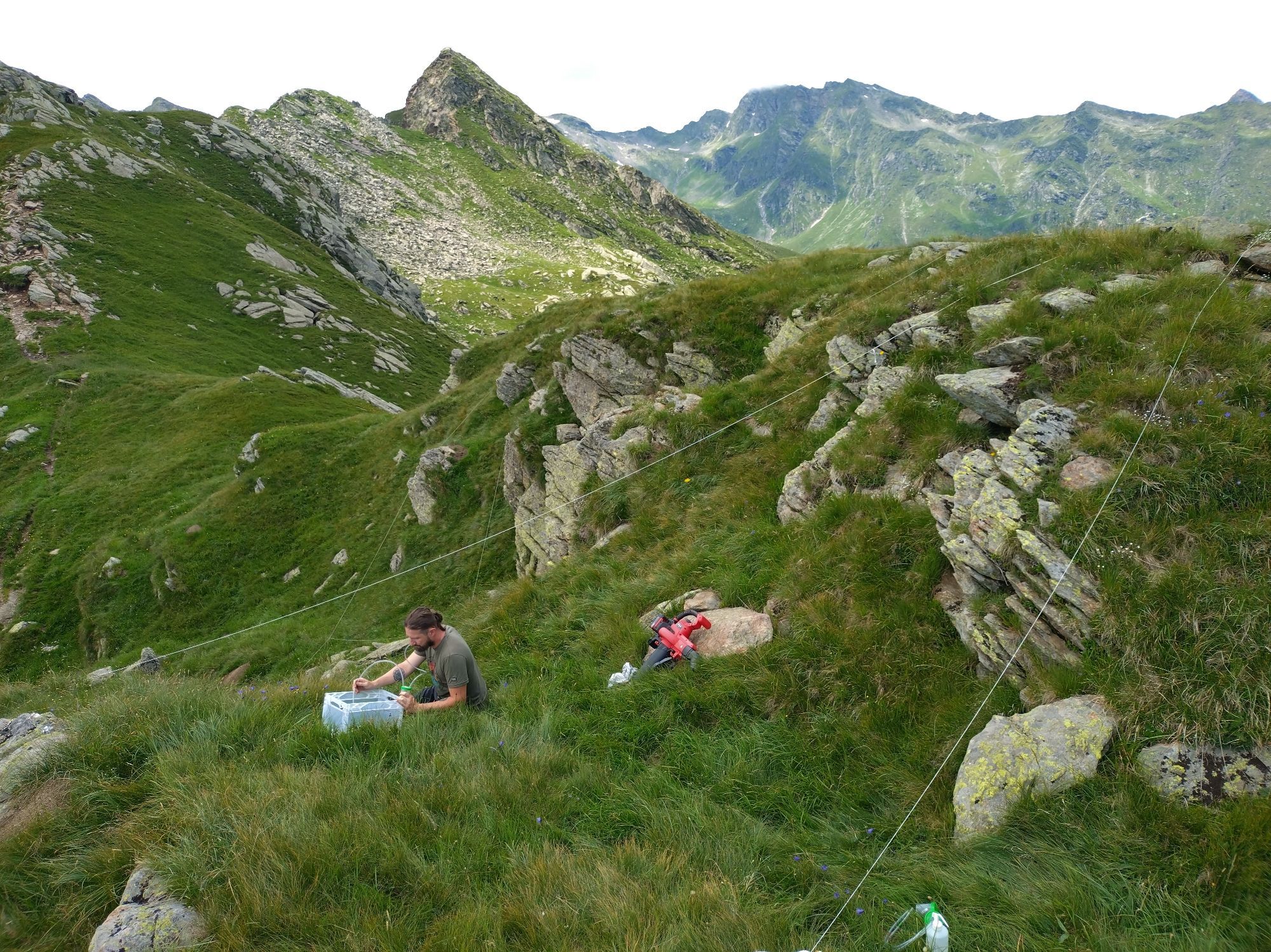 A soil biologist taking suction samples om an alpine remote peak.