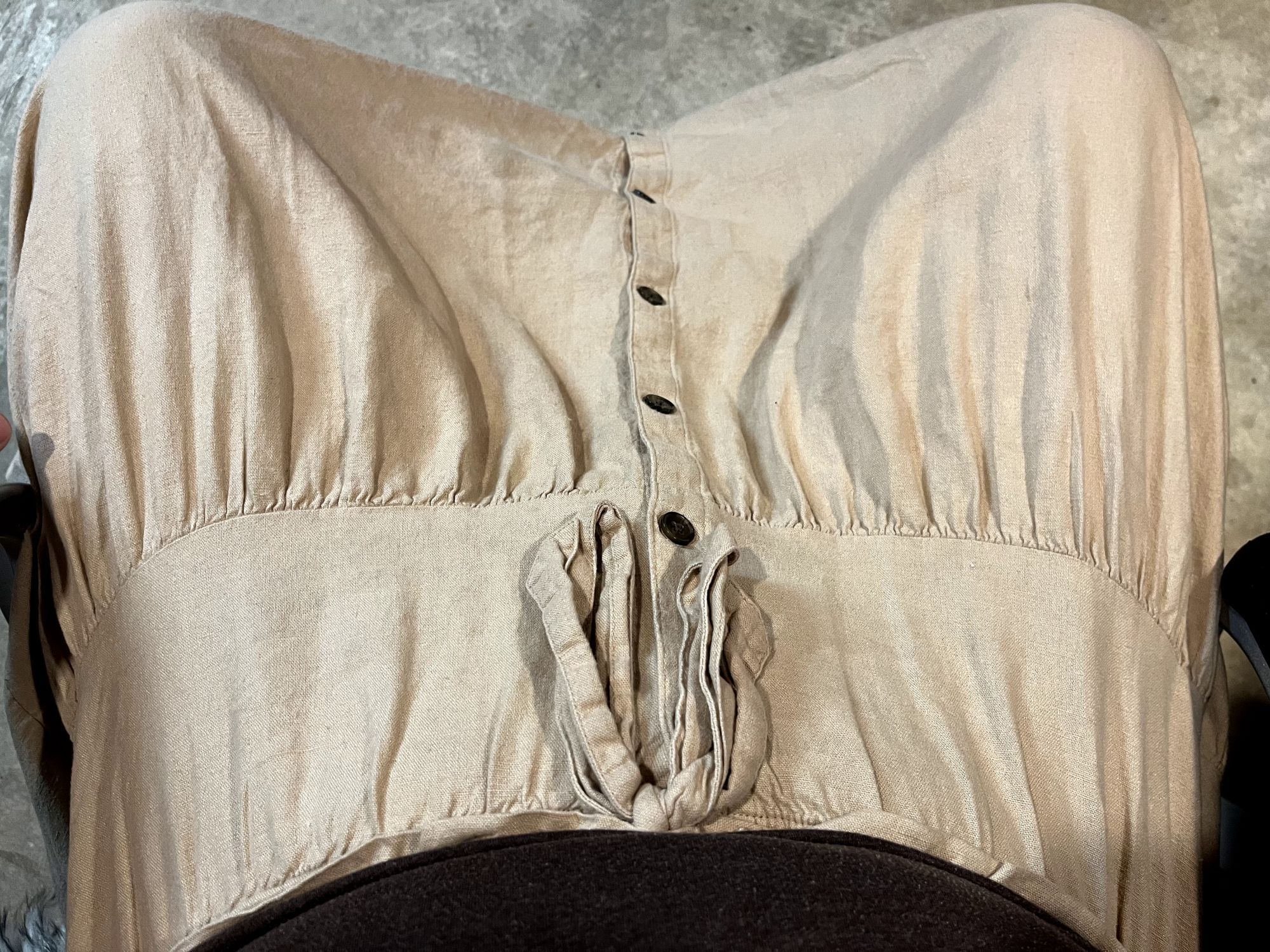 A first-person view of my lap, showcasing the flow-y skirt and buttons running down the middle.