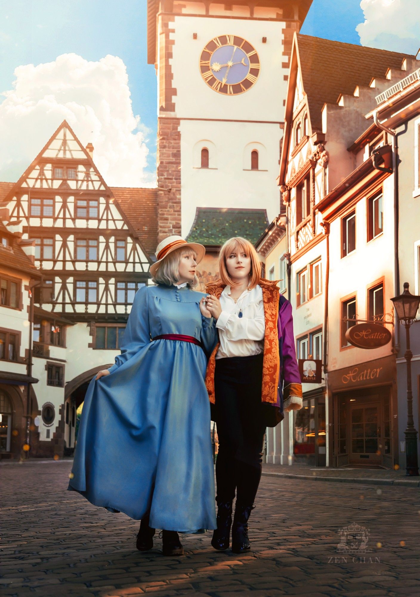 Howl and Sophie cosplayers walking hand-in-hand along a picturesque old city street, a clocktower visible in the background.