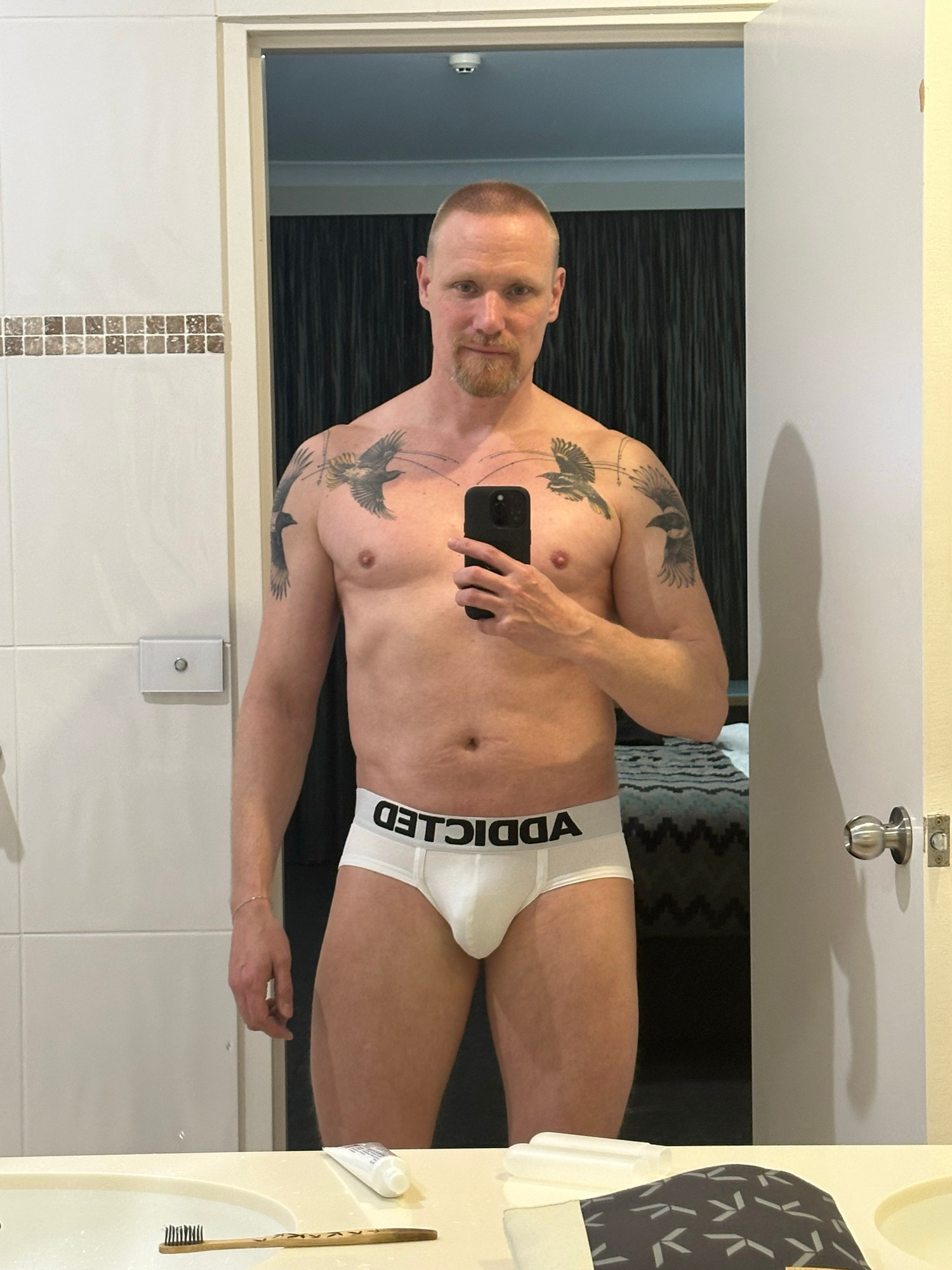 Above-the-knew mirror selfie of Timo. He’s wearing white Addicted briefs.