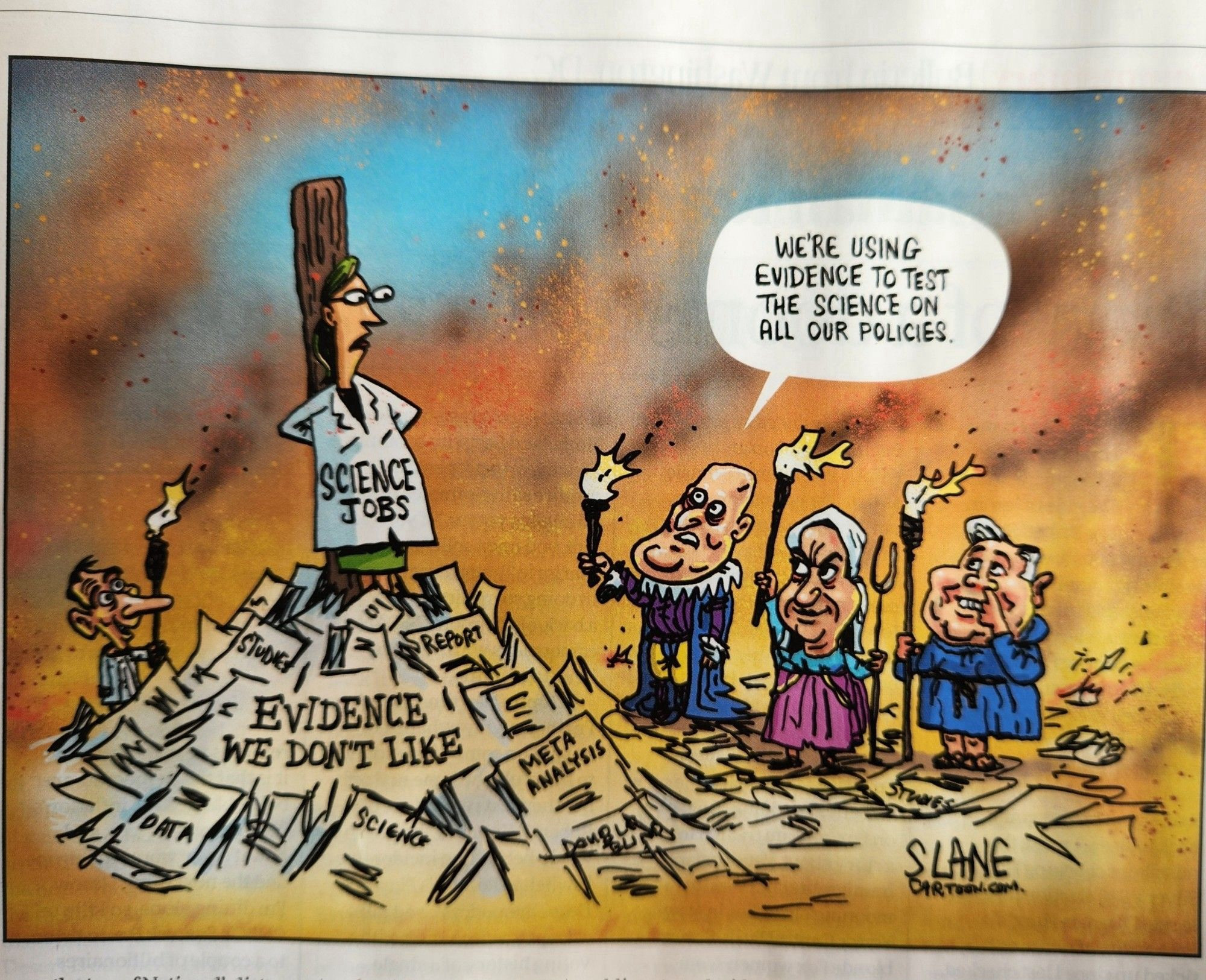 Slane cartoon, pic of a scientist about to be burnt at the stake (labelled ’science jobs’) with Luxon and other politicians standing to one side with torches. Luxon says: ‘we’re using evidence to test the science on all our policies’