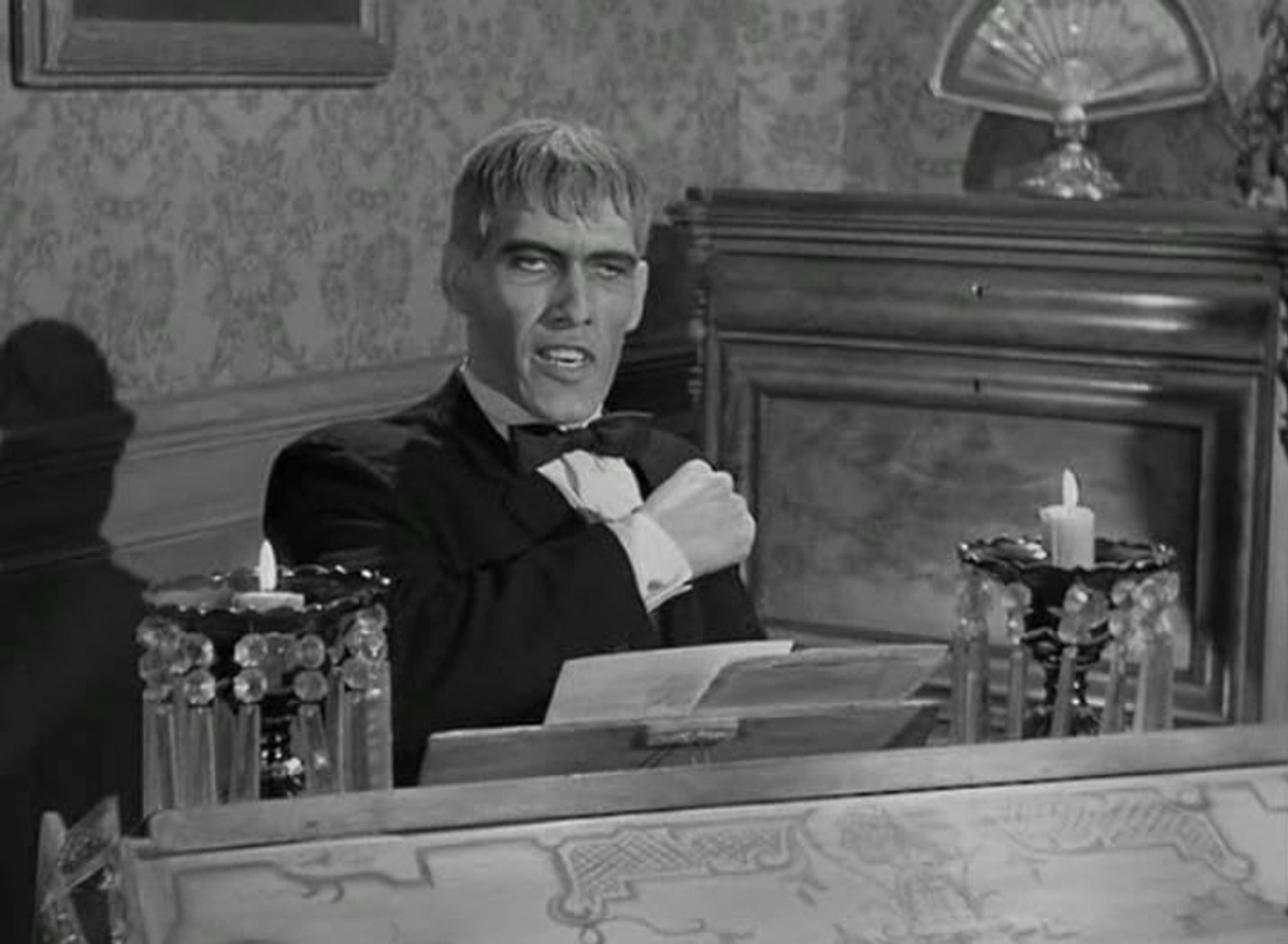 A photo of Ted Cassidy, portraying Lurch in The Addams Family (1964). He appears to be playing harpsichord.