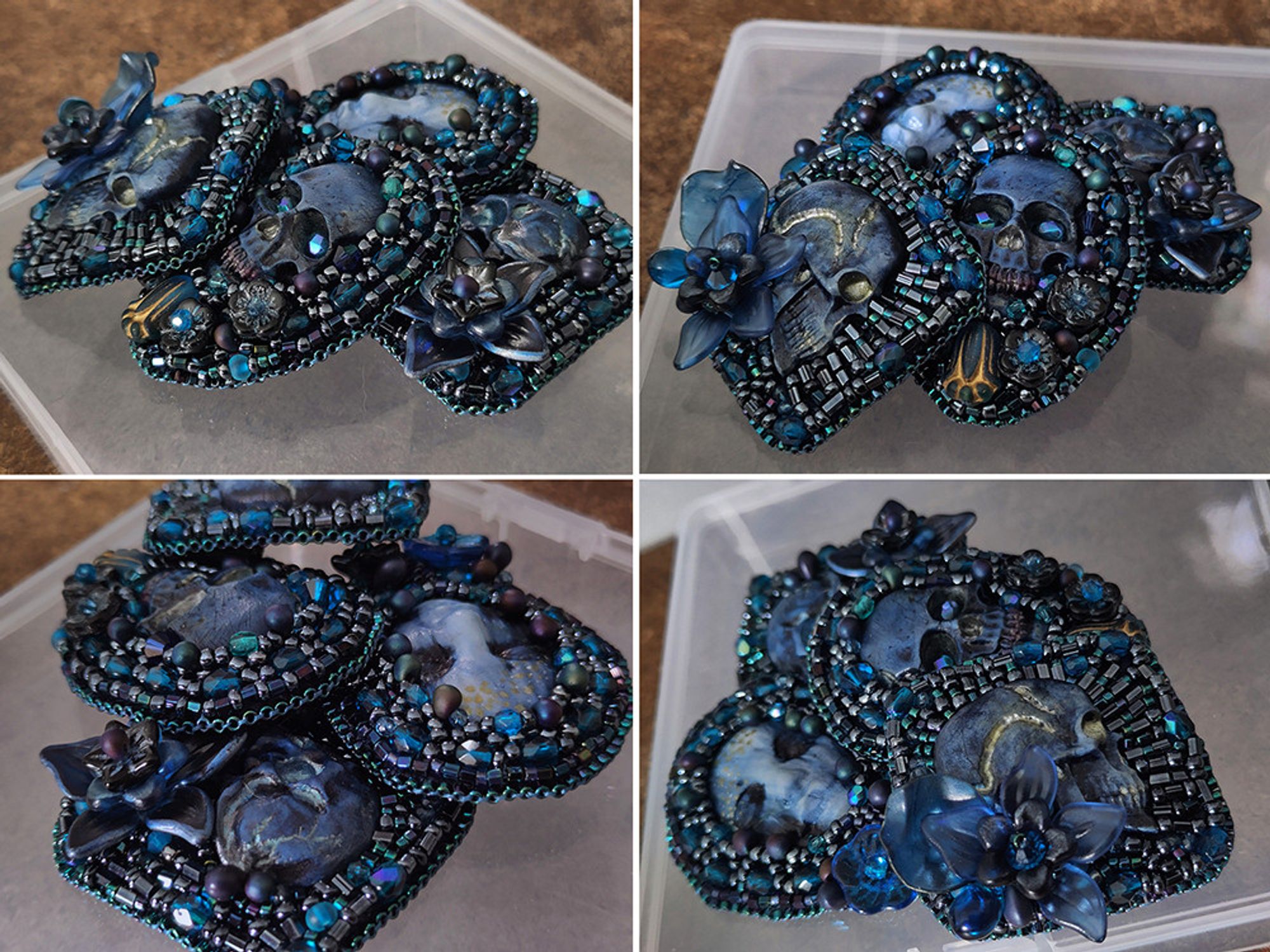 The four pendant/brooches clustered together at different angles to showcase them. The face and the skulls are made of fimo painted in shades of blue with golden and silver accents. they are surrounded by seed beads embroidery in various patterns in the same colors, with added glass and lucite flowers in dark blue shade. The patterns and the flowers are different on each.