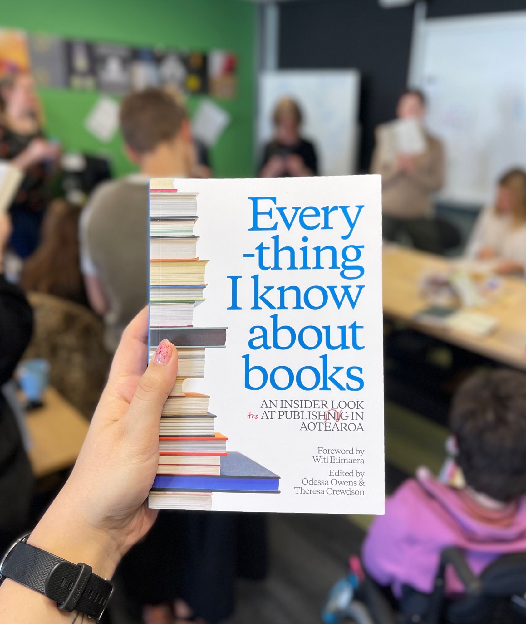 The book Everything I Know About Books with a blurry background of the Whitireia classroom.