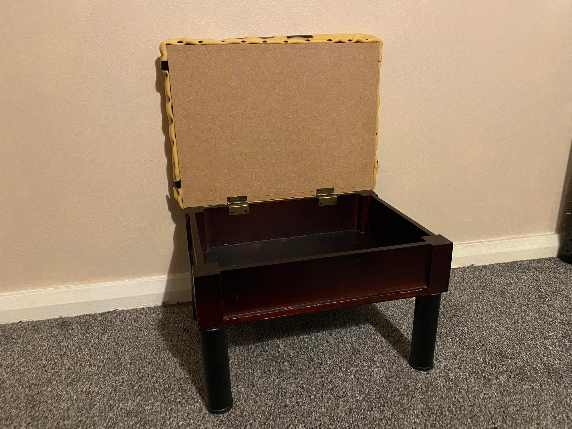 Footstool with a new MDF lid with the foam attached opened. Front view.