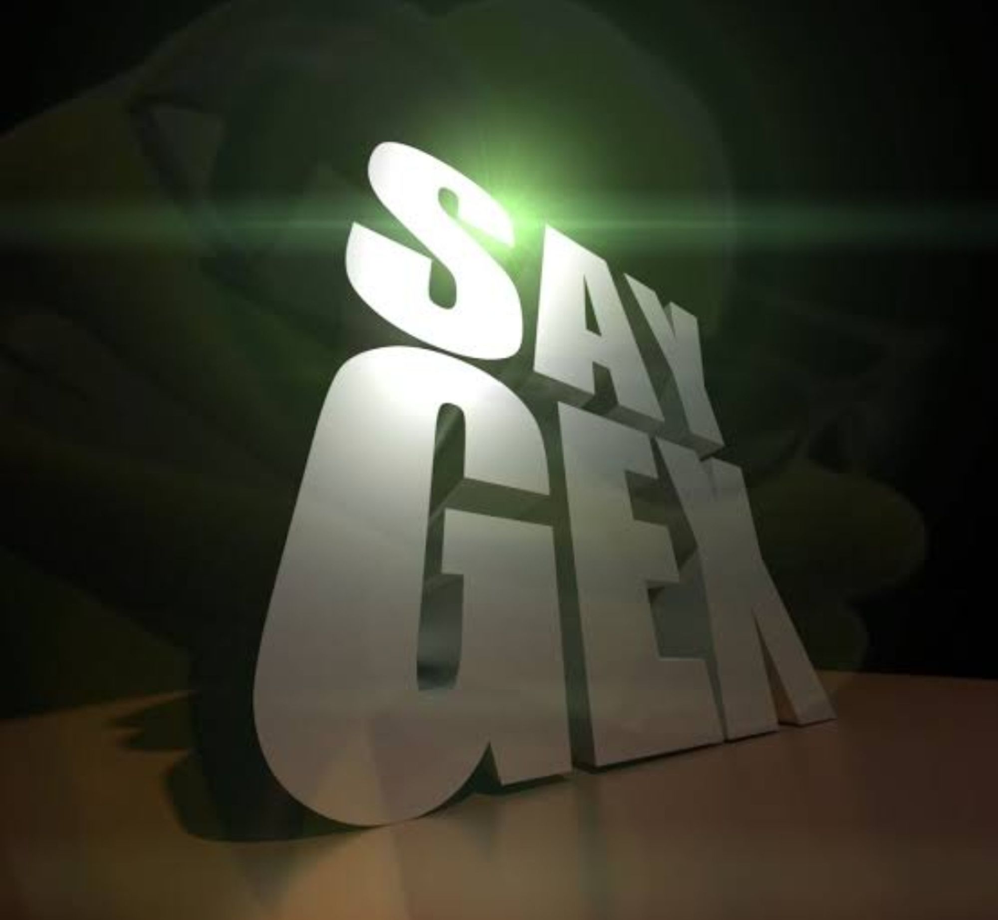 3d text that says "SAY GEX", a joke aimed to be confused with GAY SEX