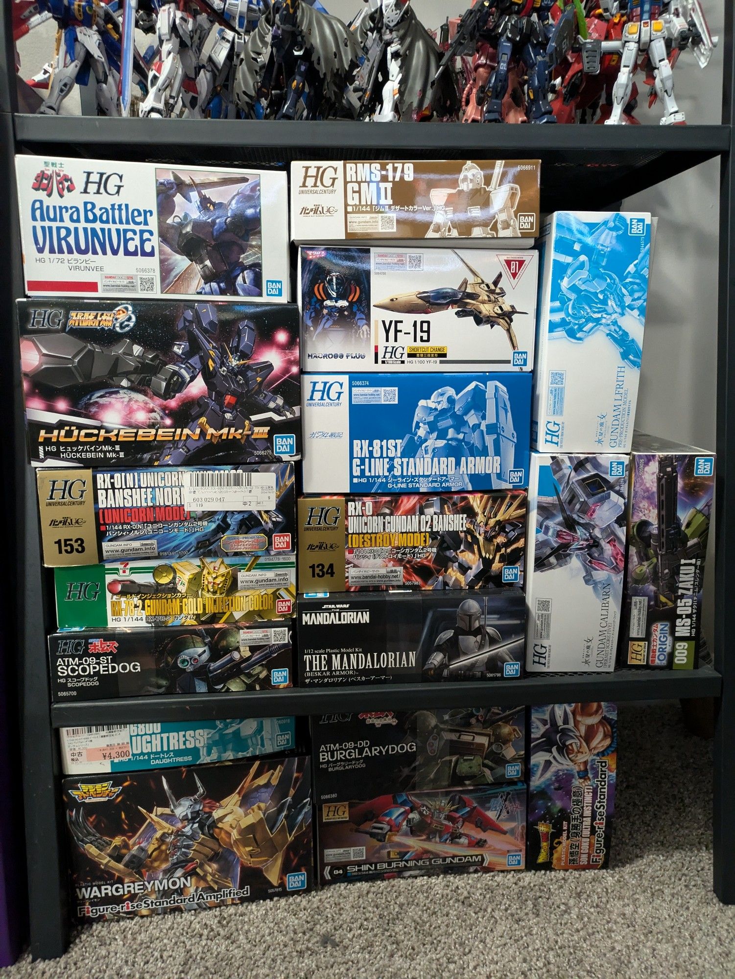 Main model kit shelf. Some of the standouts include the 7-11 RX-78-2, the Votoms kits, a fancy Wargreymon, and way too many P-bandai kits