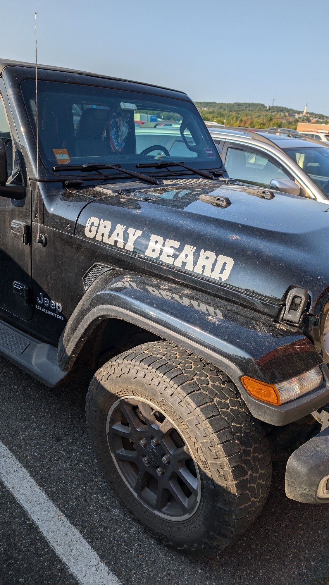 Photo of a black jeep with the words "Gray Beard" along the hood.