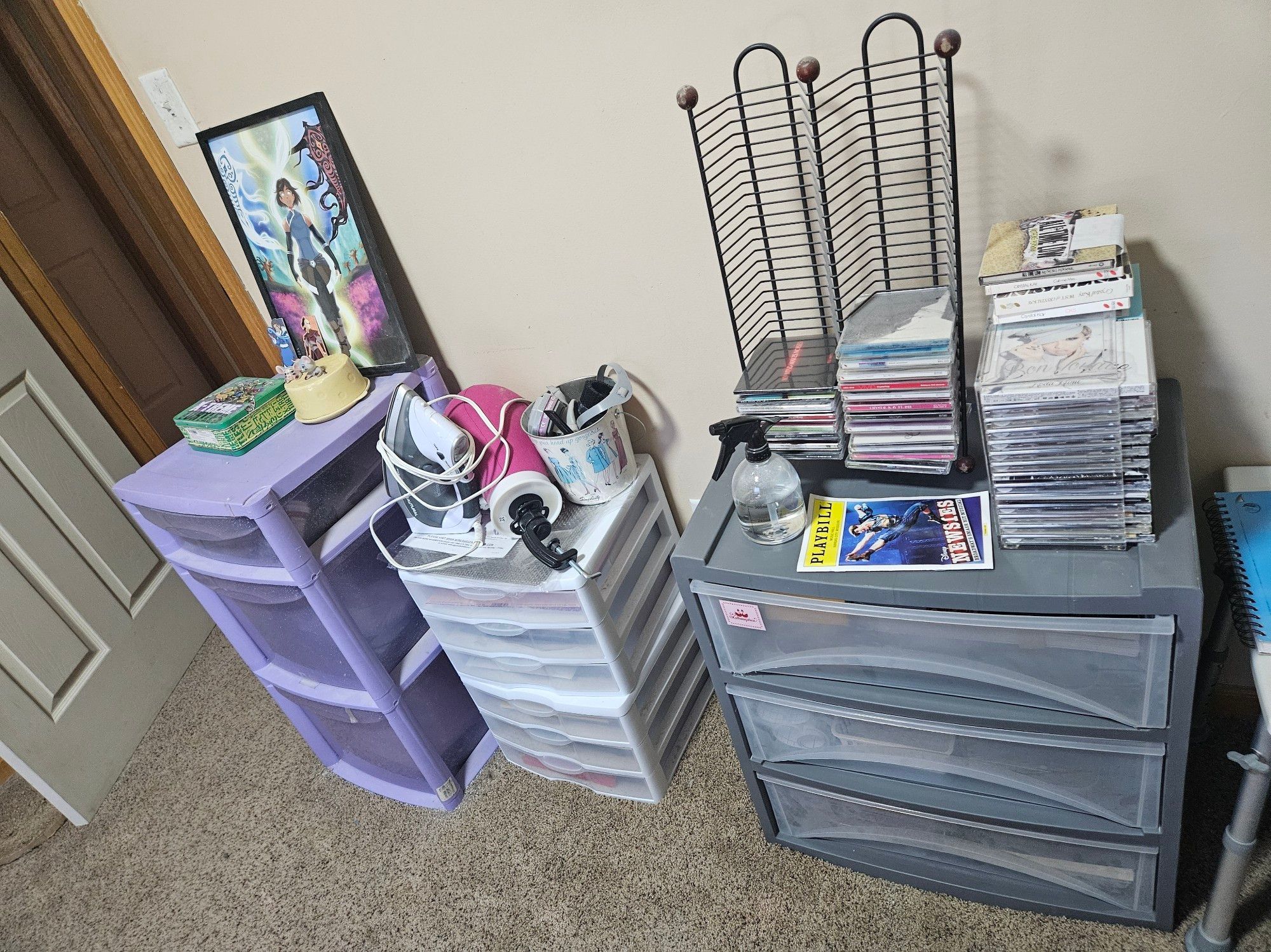 Four plastic storage drawers with various things on top of them