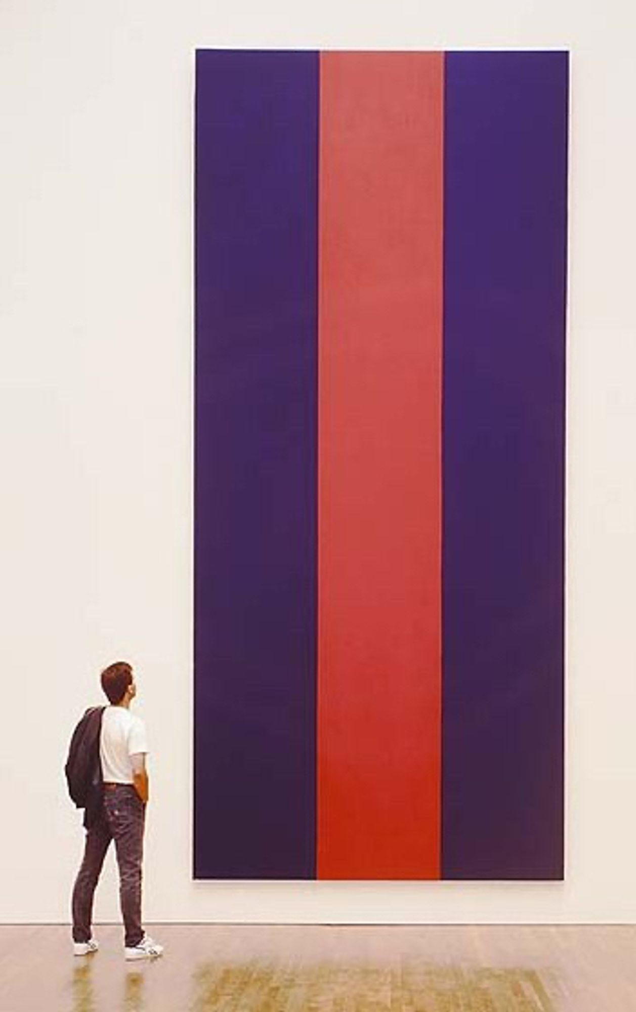 a little white guy in jeans and a white t-shirt looks up in awestruck contemplation at barnett newman's voice of fire, an 18 ft tall painting of one red and two dark blue vertical stripes, which now hangs in the national gallery of canada. newman painted it in 1967 for the us pavilion at the montreal world fair, so it's a newman with a canadian connection, which didn't stop some people from complaining when the national gallery purchased it from newman's widow.