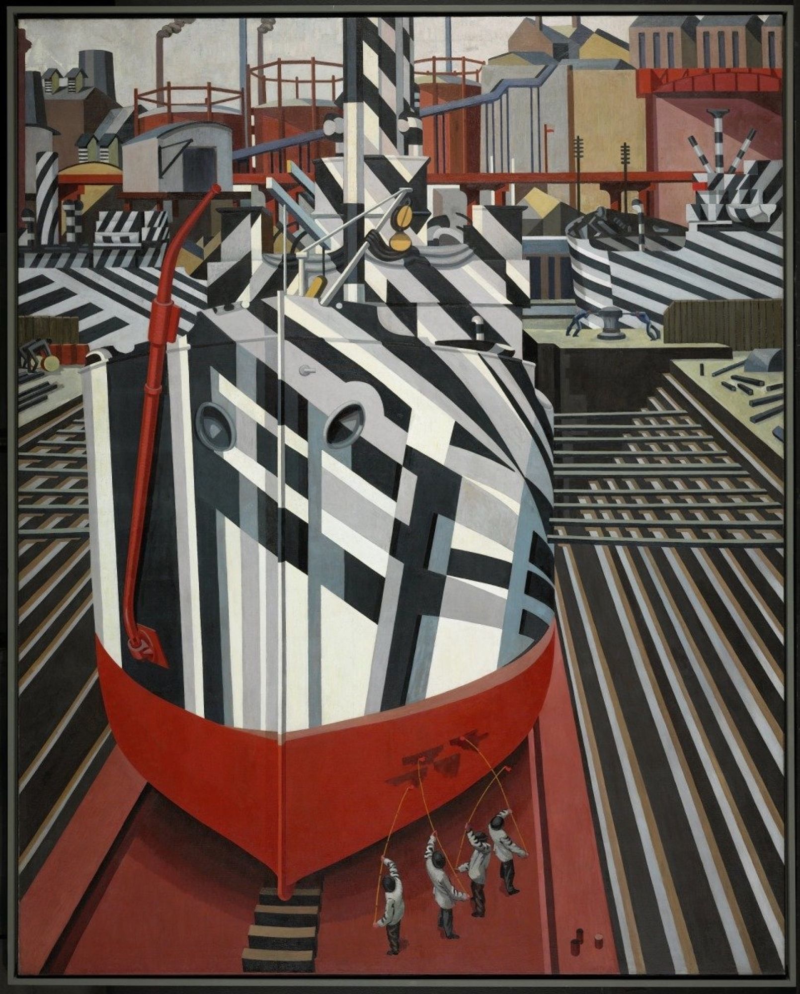 the prow of a giant warship crisscrossed with black white and grey angled bands fills the center of edward wadsworth's 3 meter tall painting, dazzleships in dry dock at liverpool. four little guys in grey paint the red hull at bottom, while pipes and beams of the dock echo the ship's adapted dazzle pattern. the background is a geometric jumble of other dazzle painted ships poking in from the sides and gas tanks and warehouses at the back. via the national gallery of canada