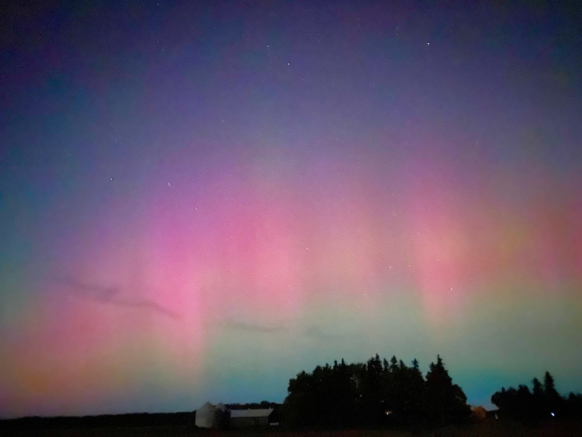 Northern lights over a farm 