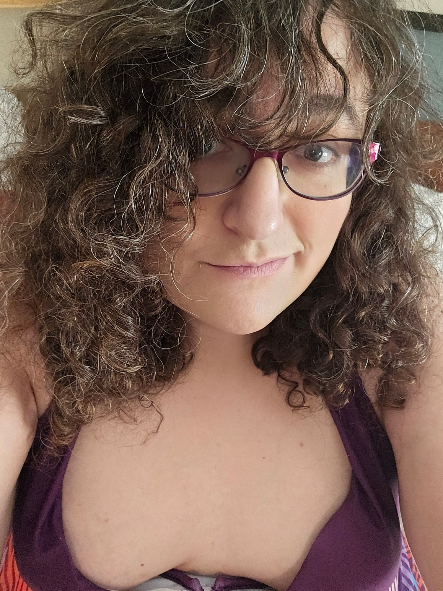 Curl haired brunette woman wearing swimsuit