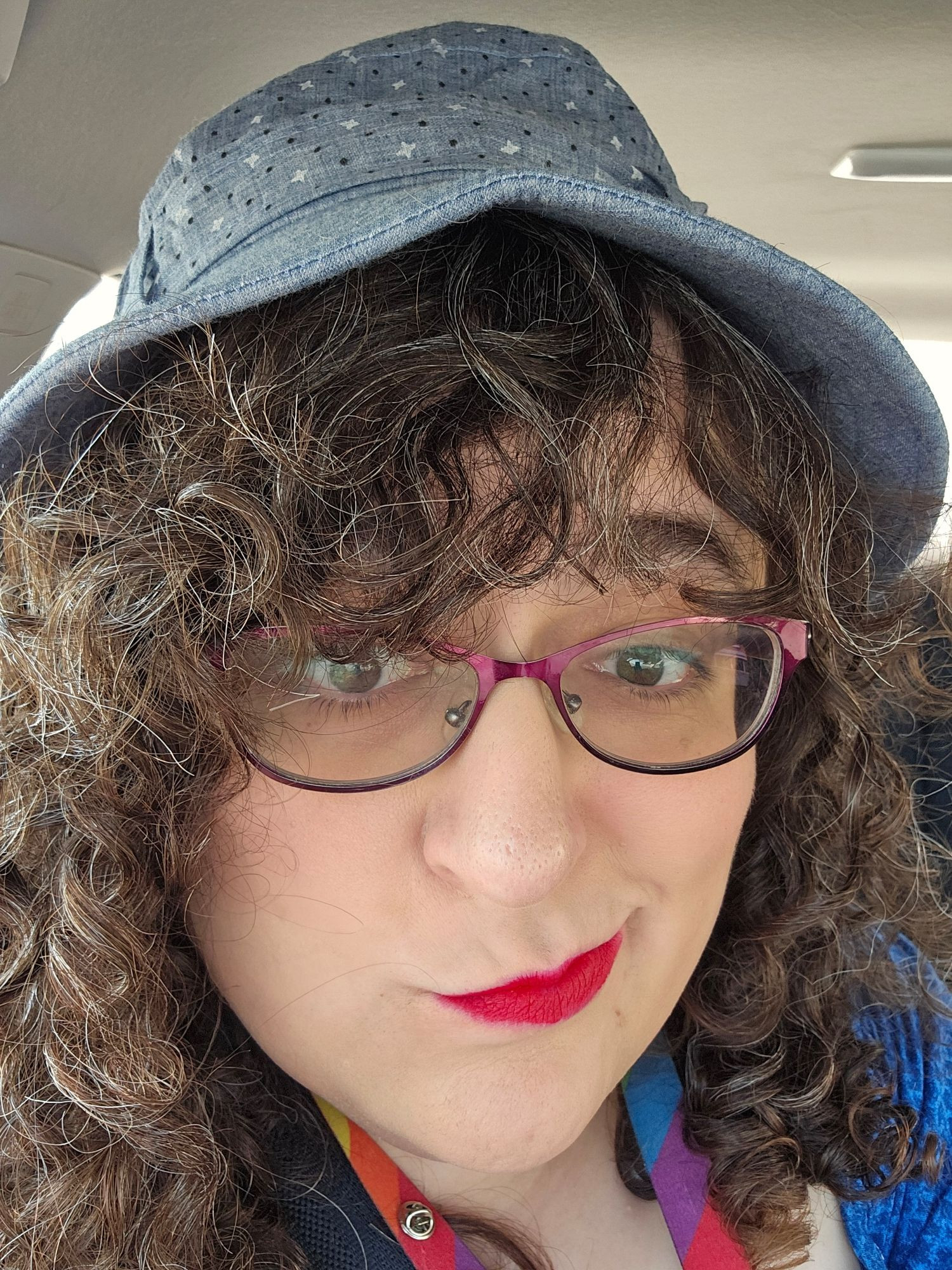 Picture of curly haired woman with bright red lipstick.