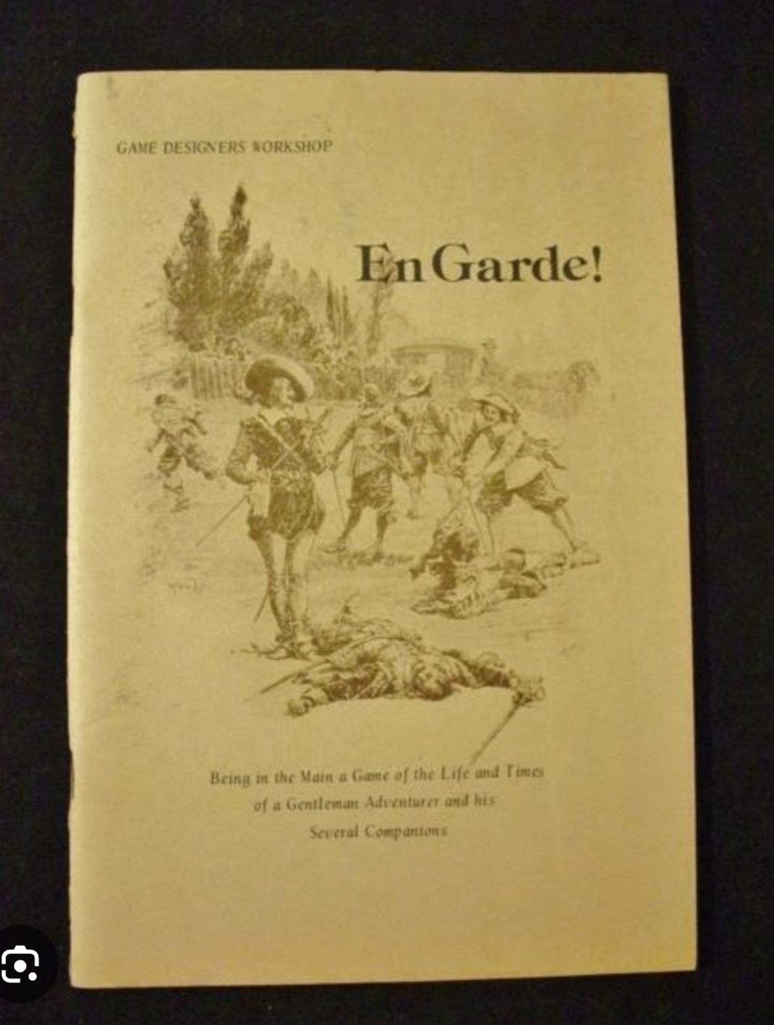 The yellowing monochrome cover of the old rpg En Garde. It features several musketeers fighting and or dying.