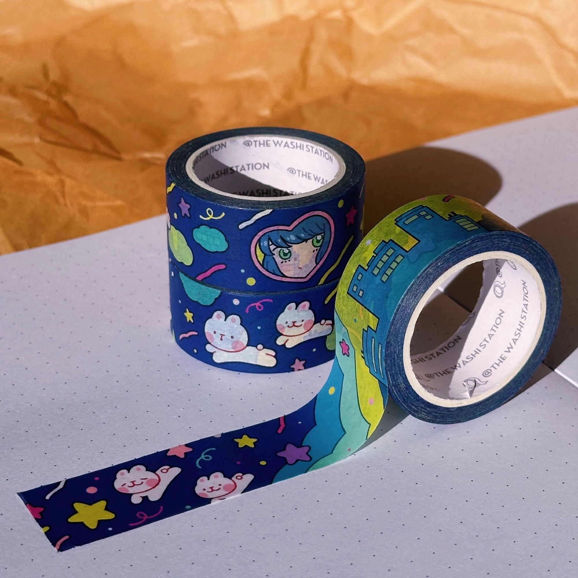 Photo showing a washi tape design called Starlight Pop, depicting a nighttime cityscape interspersed with dancing bunnies and shooting stars.